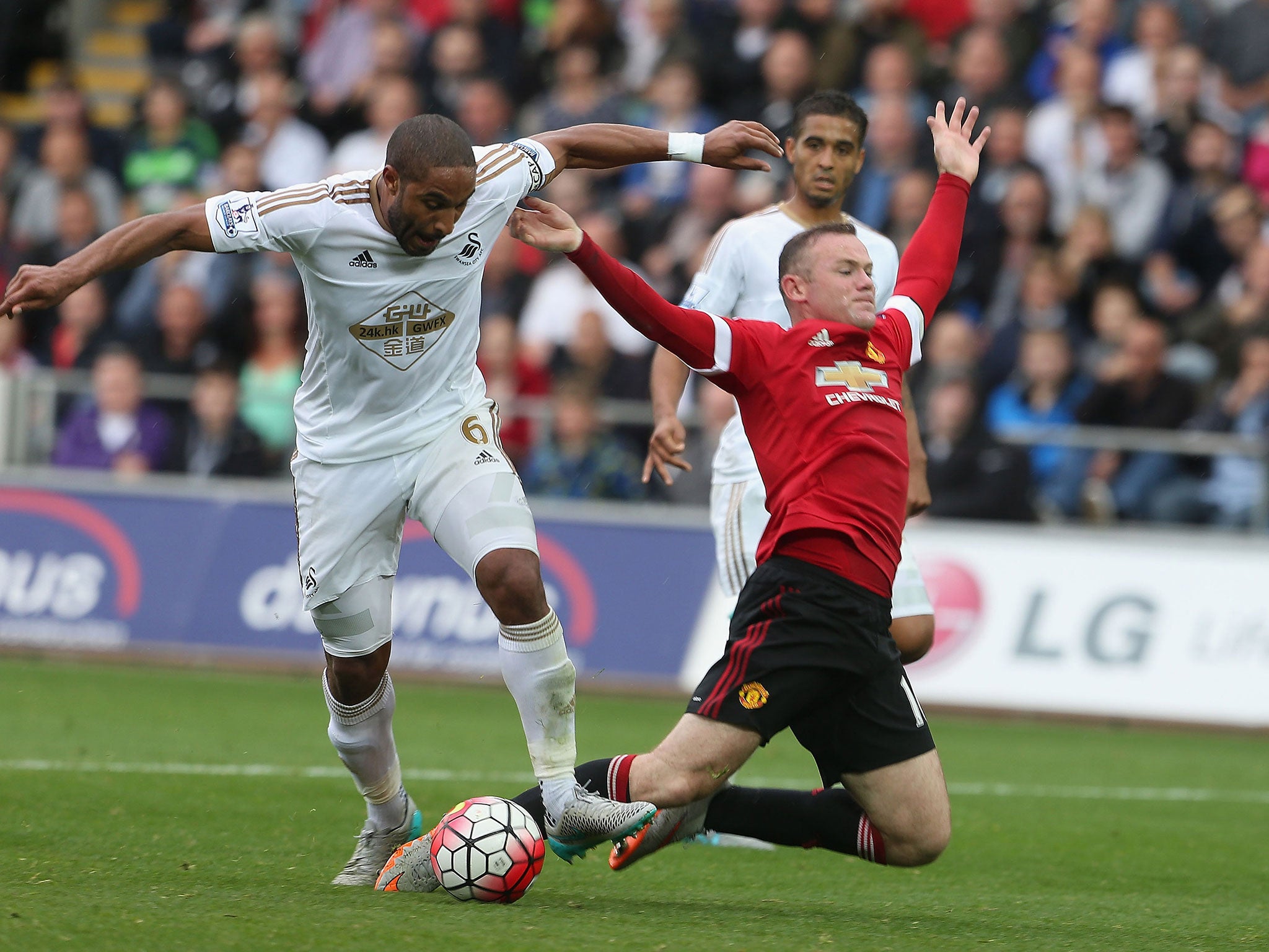 Wayne Rooney goes down under the challenge of Ashley Williams