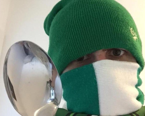 A Celtic supporter holds a spoon in response to Fenerbahce 'threats'
