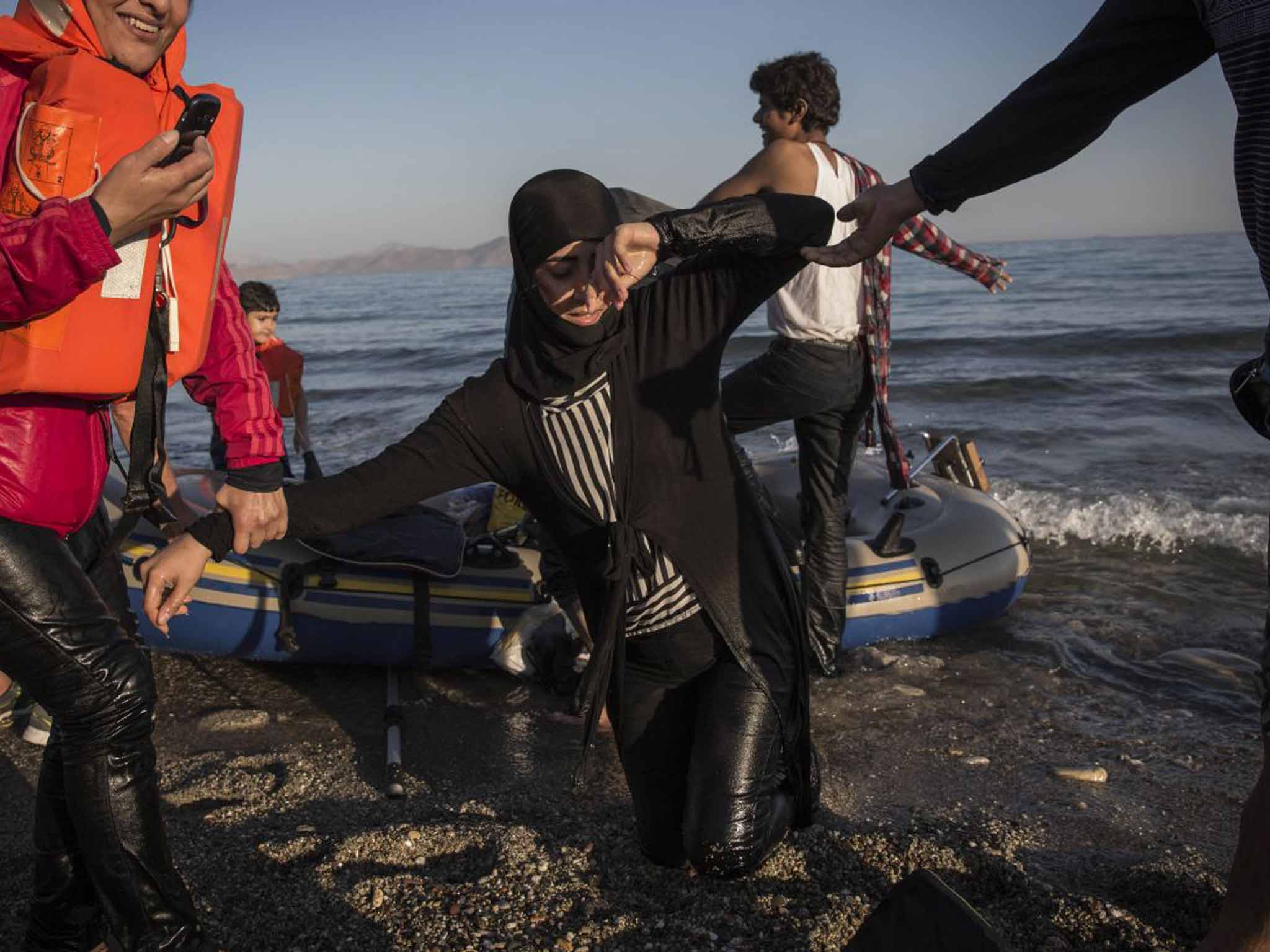 Desperate measures: a Syrian woman arrives in Kos on a dinghy from Turkey