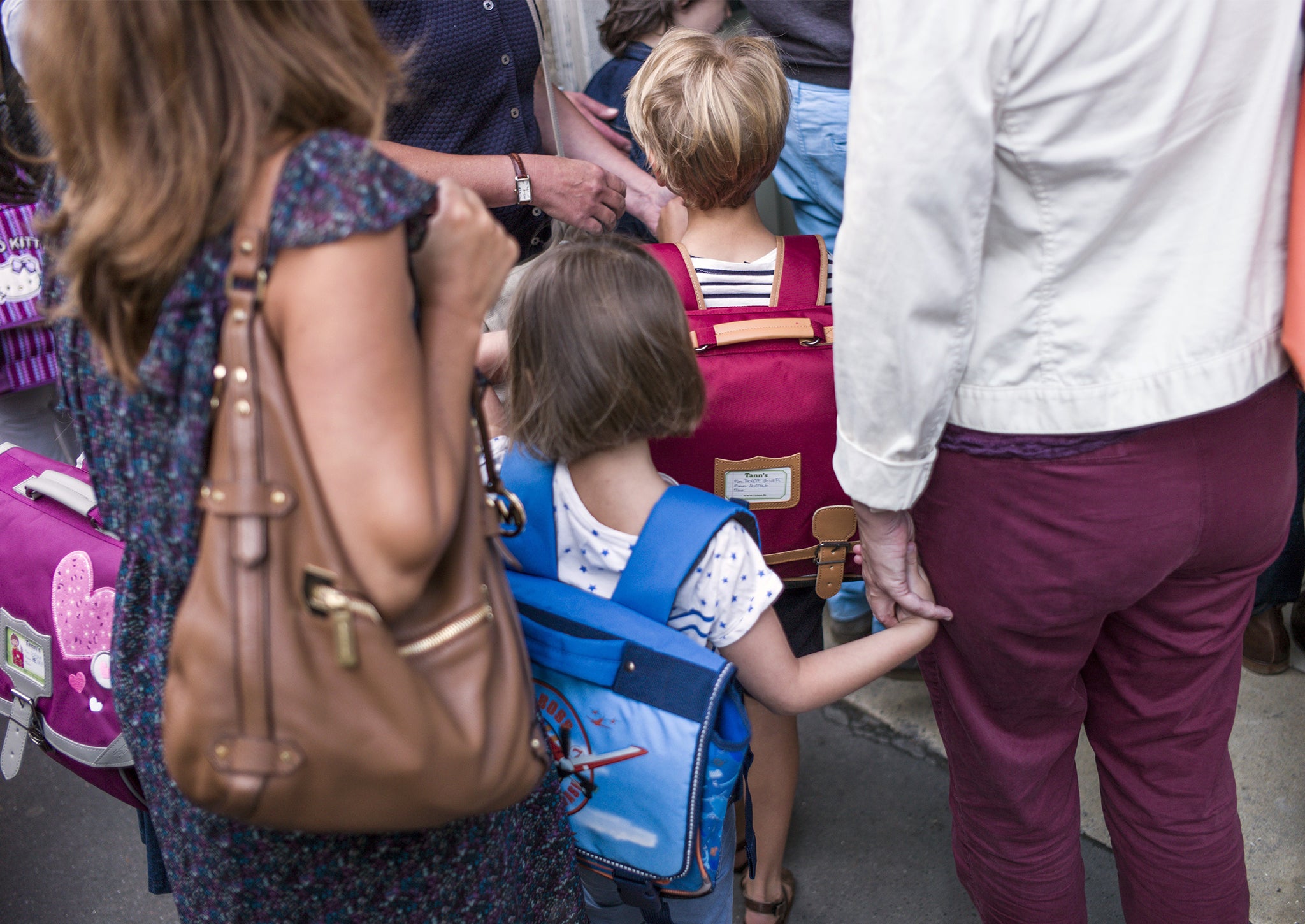 Pupils arrive at school with their parents at the start of a new school year