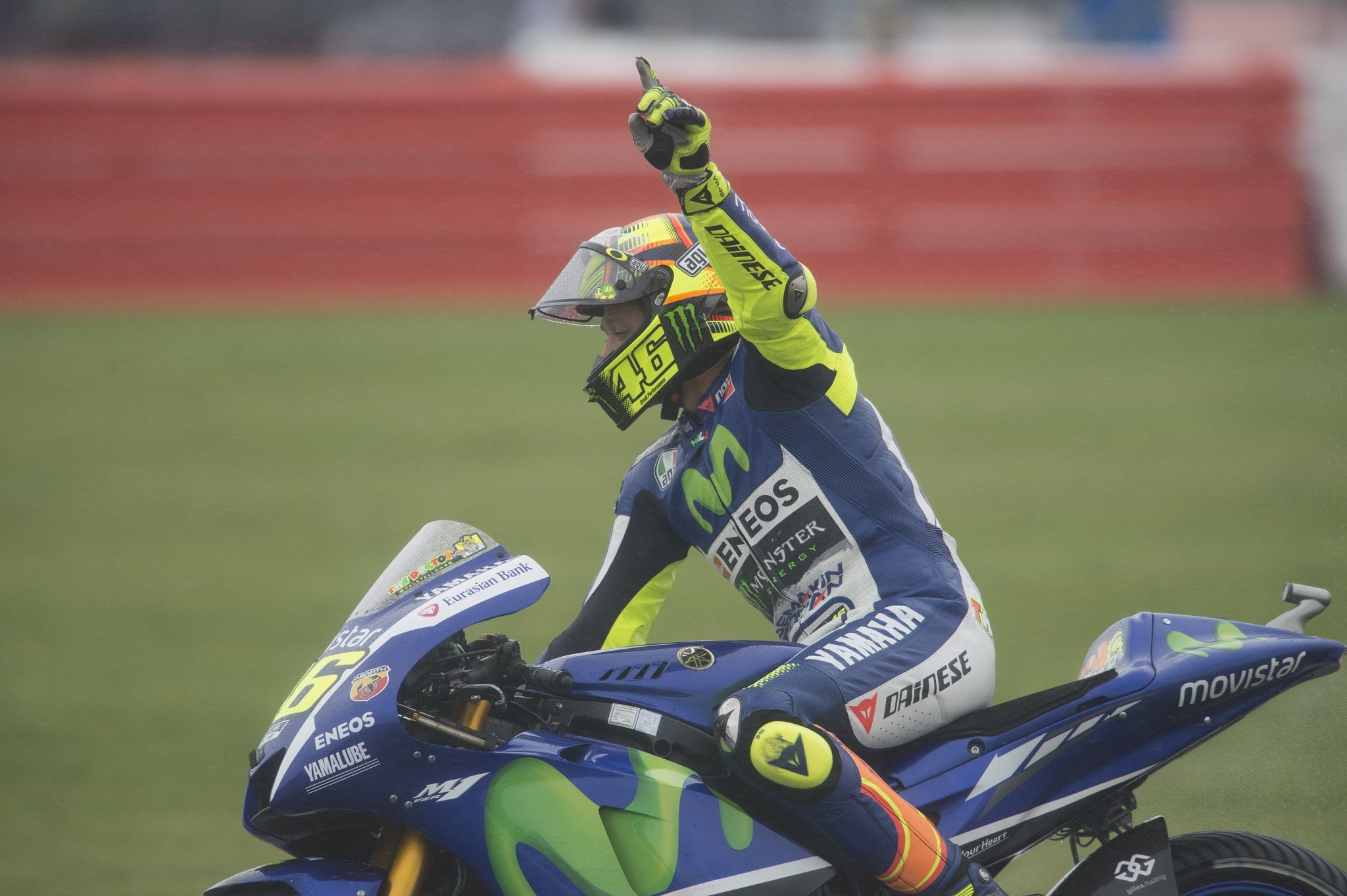Valentino Rossi salutes the crowd after taking victory in the British Grand Prix