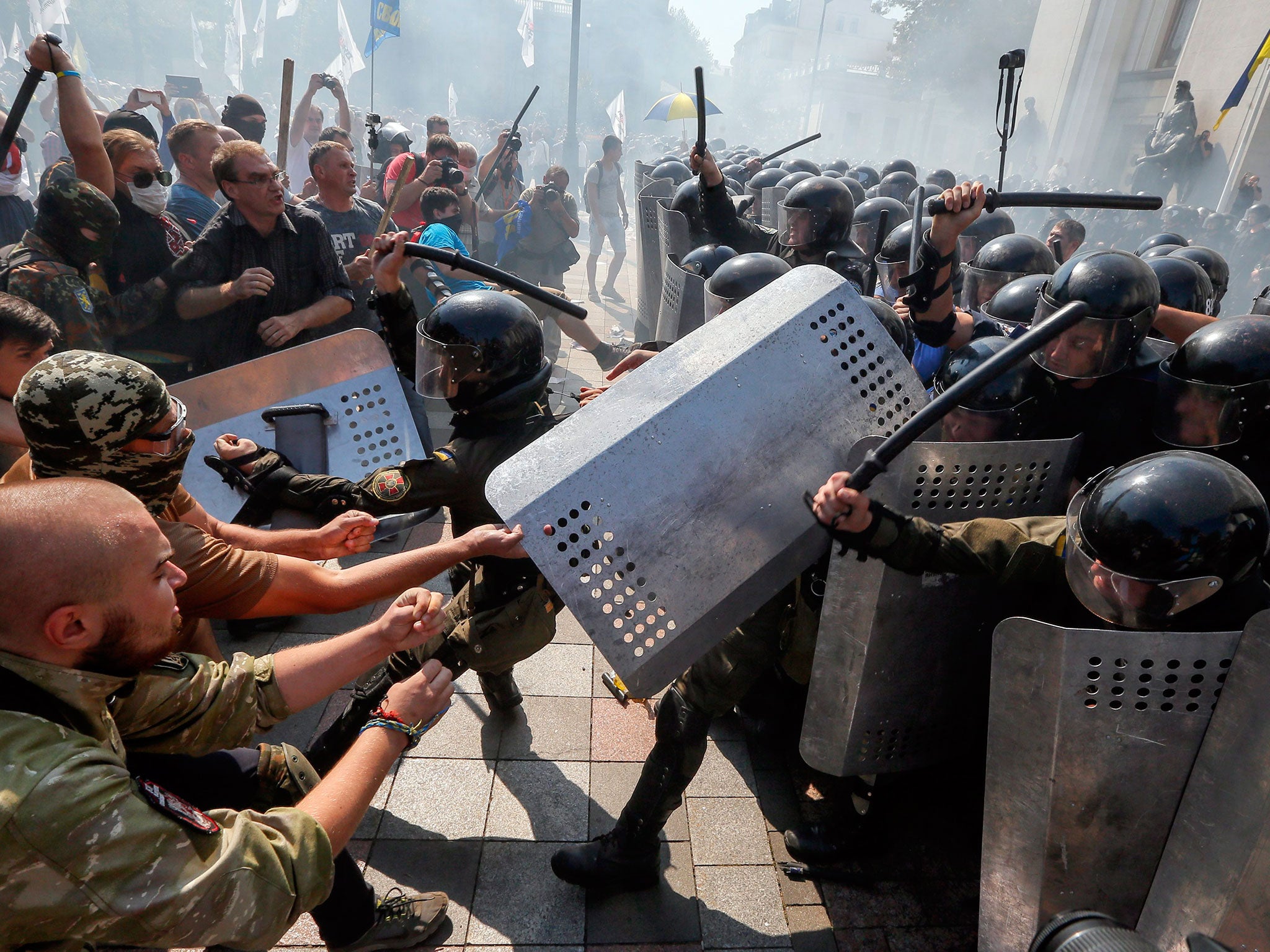 Opponents of changes to the Ukrainian constitution clash with police in front of the Ukrainian parliament in Kiev yesterday as MPs accepted the decentralising of power in the first reading