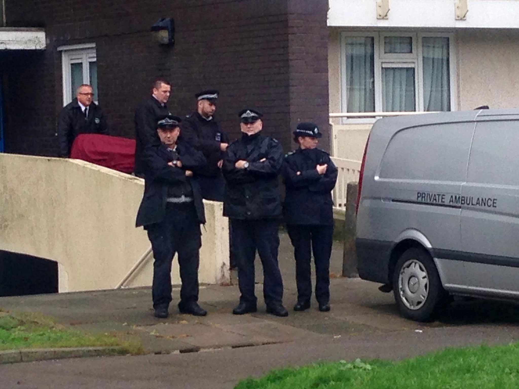 A body is removed from Picardy house on Cedar Road in Enfield, London, after armed police officers shot dead a man who had a gun and was threatening to kill someone