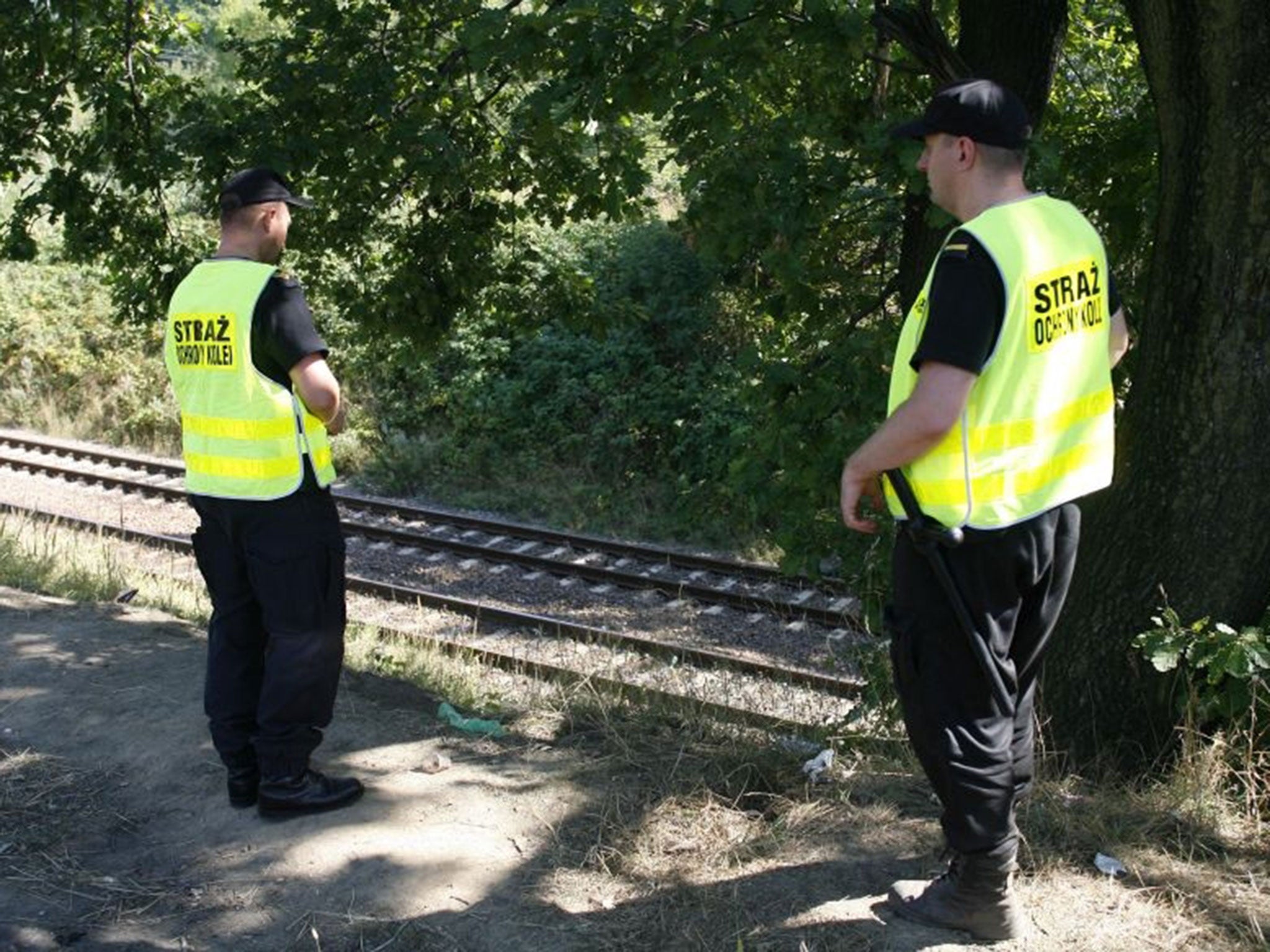 Railway guards patrolling tracks to prevent gold hunters and history buffs from getting harmed by passing trains near the site where two men allegedly found a Nazi gold train hidden underground near Walbrzych, Poland, on Monday, Aug. 31, 2015. Authorities