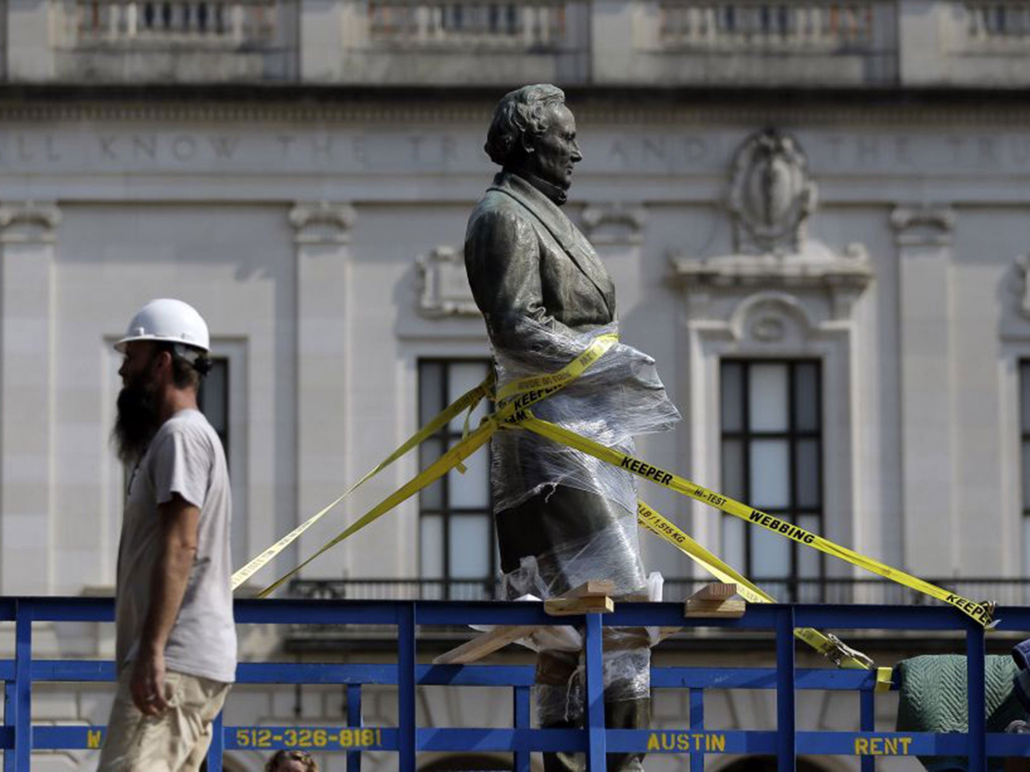A statue of Confederate President Jefferson Davis is moved from its location in front of the school's main tower the University of Texas campus