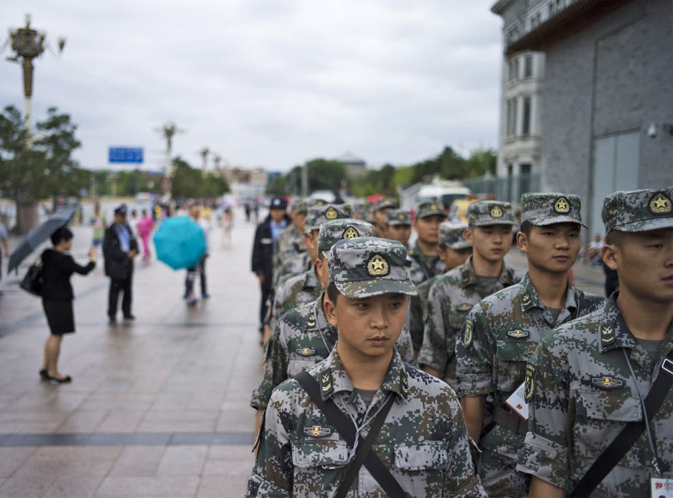 Chinese soldiers in Tiananmen Square prepare the area before a parade to mark ‘victory’ over Japan