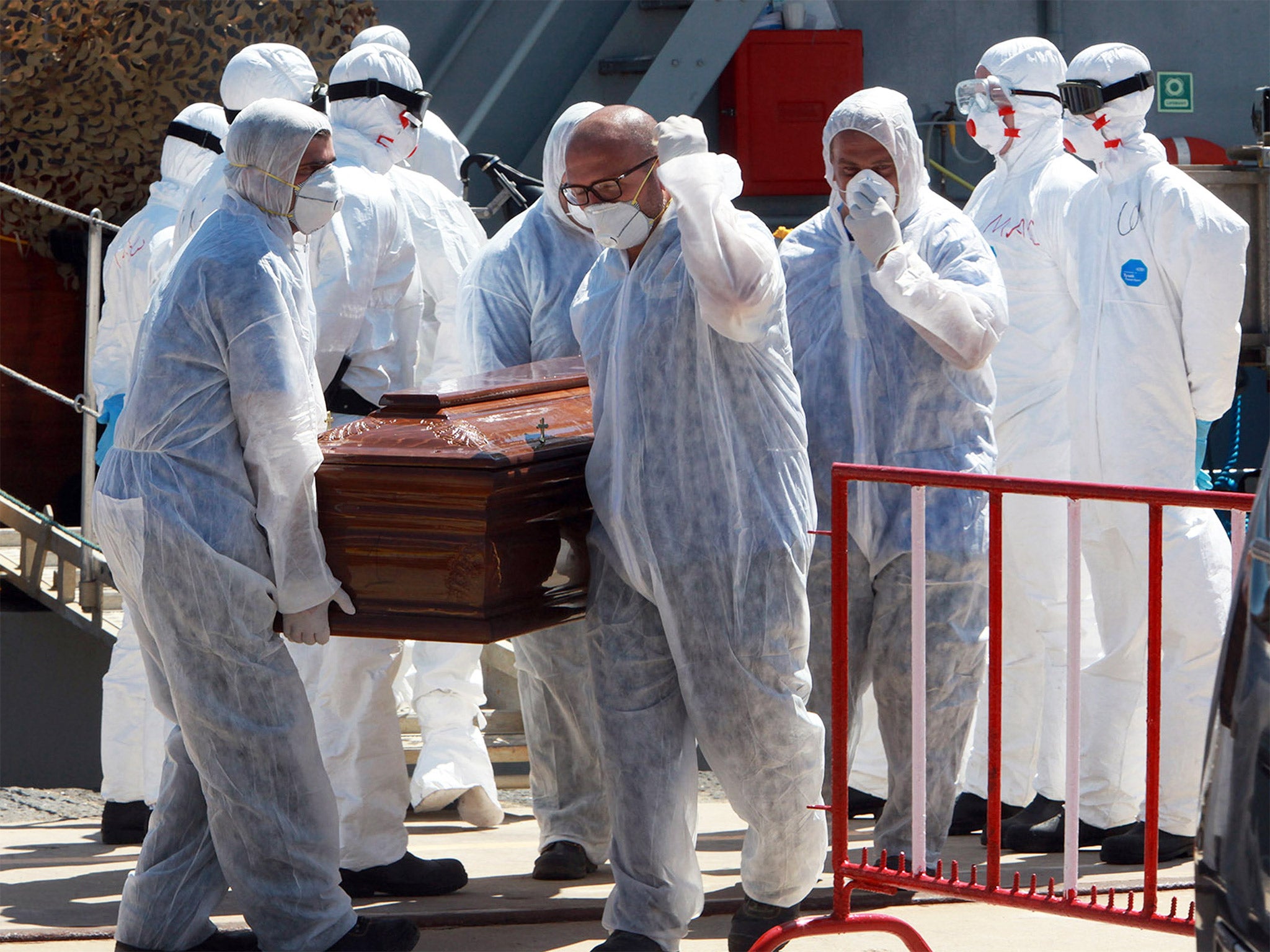 Italian soldiers at Messina in Sicily carry one of the 13 coffins of refugees who died attempting to cross the Mediterranean in July