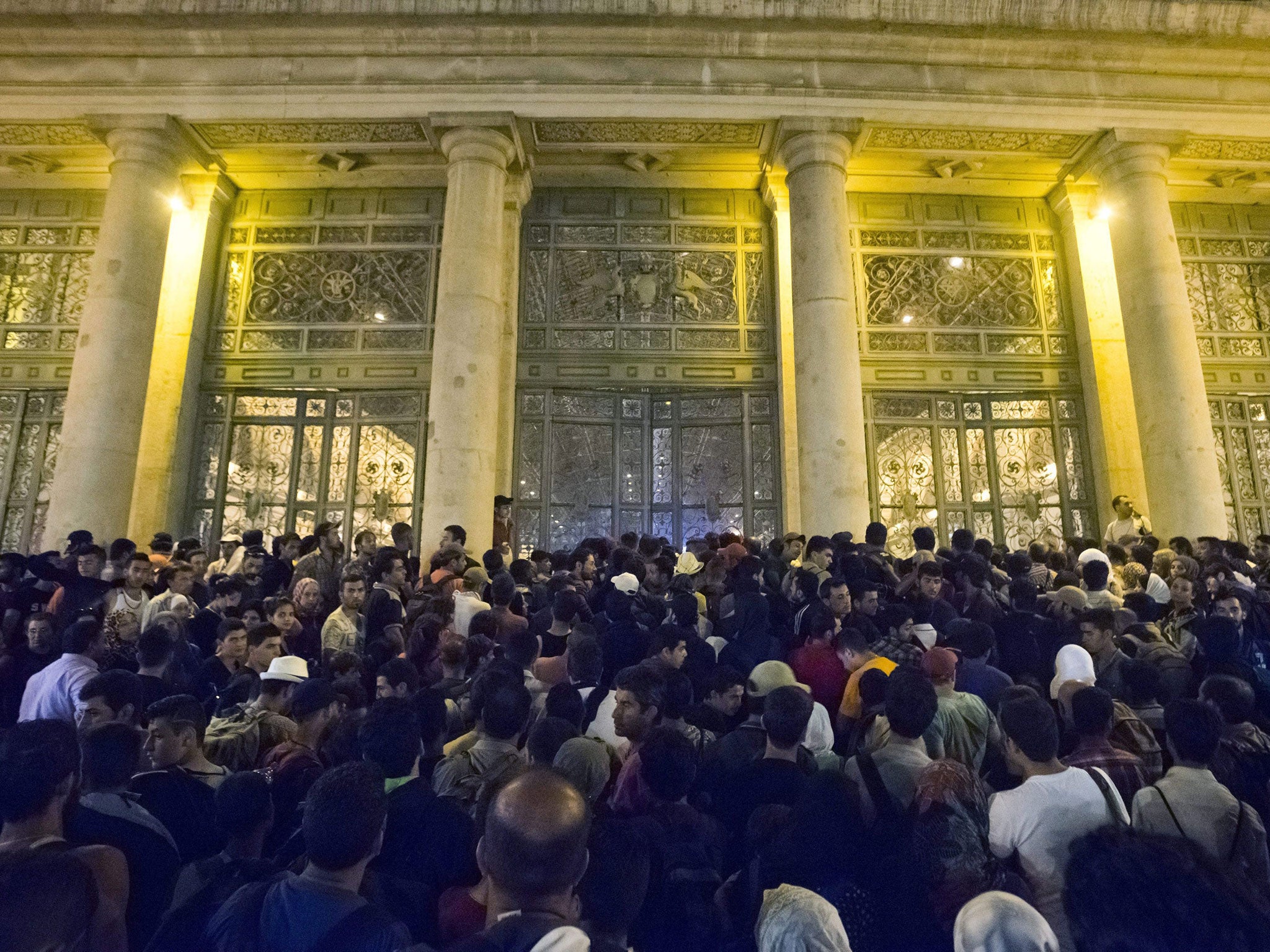 Migrants wait to board a train to Germany at the Keleti Railway Station in Budapest, Hungary, 1 September 2015
