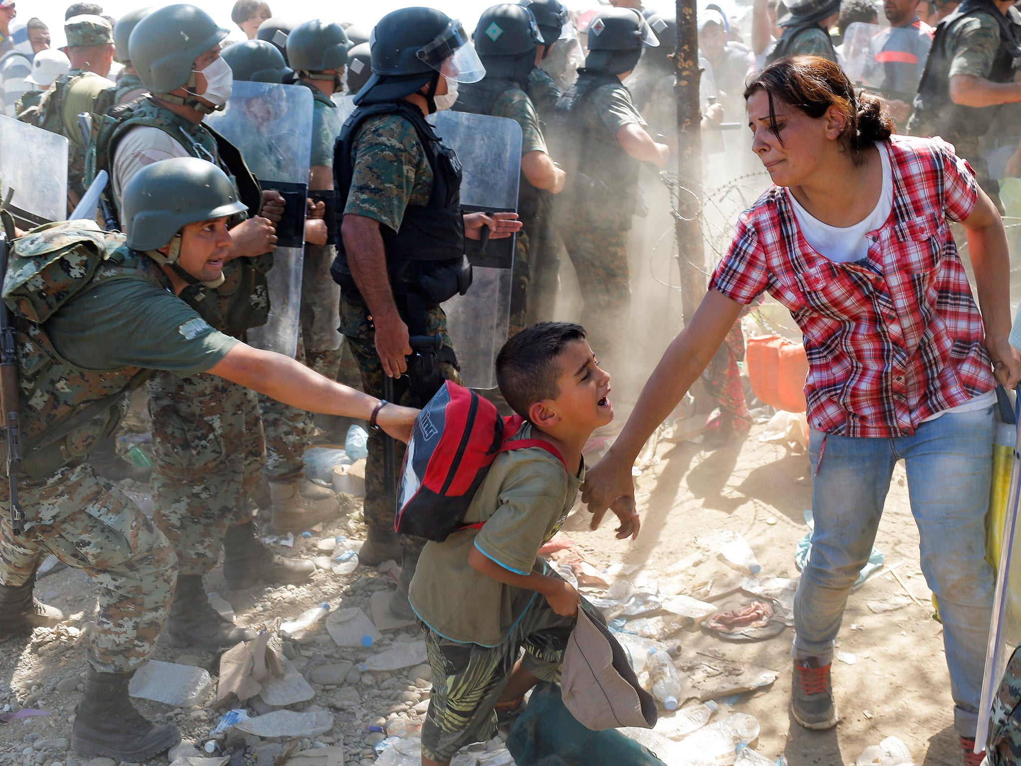 Refugees cross the border between the Former Yugoslav Republic of Macedonia and Greece, near the town of Gevgelija, Macedonia.