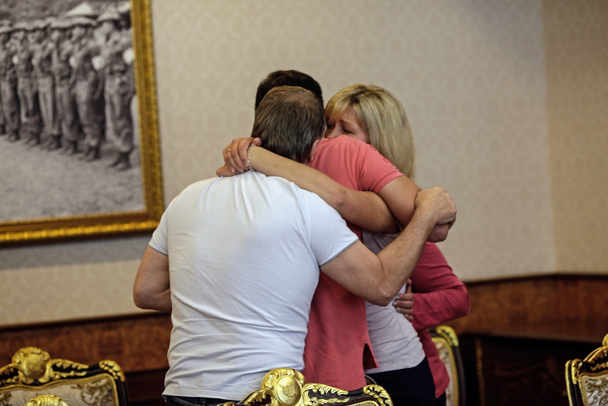 Hannah Witheridge's relatives hug ahead of a police briefing in Bangkok, three days after the young woman was found dead.