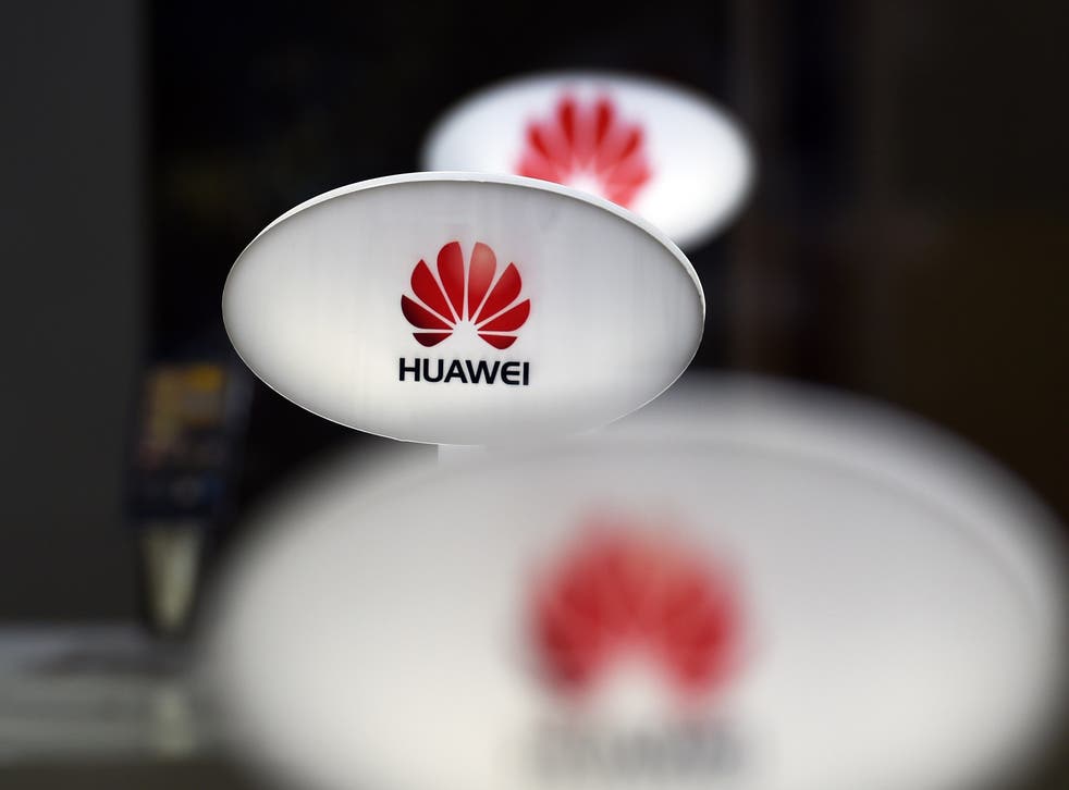Signs for Chinese telecom equipment maker Huawei are displayed in a store selling mobile phones in Beijing on August 3, 2015