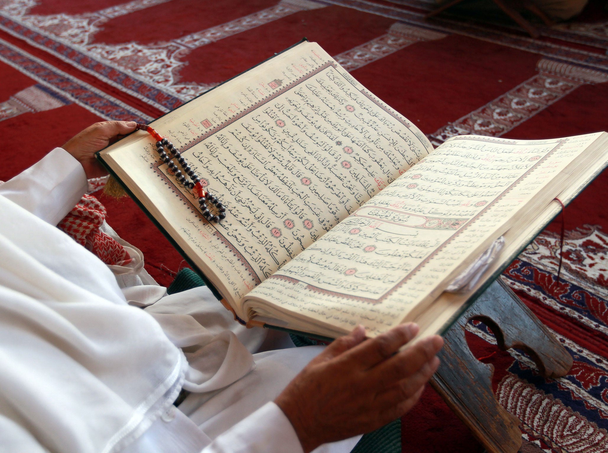 A man reads a Koran in a mosque in Sanaa. At least 20 people have died in twin blasts in the capital.