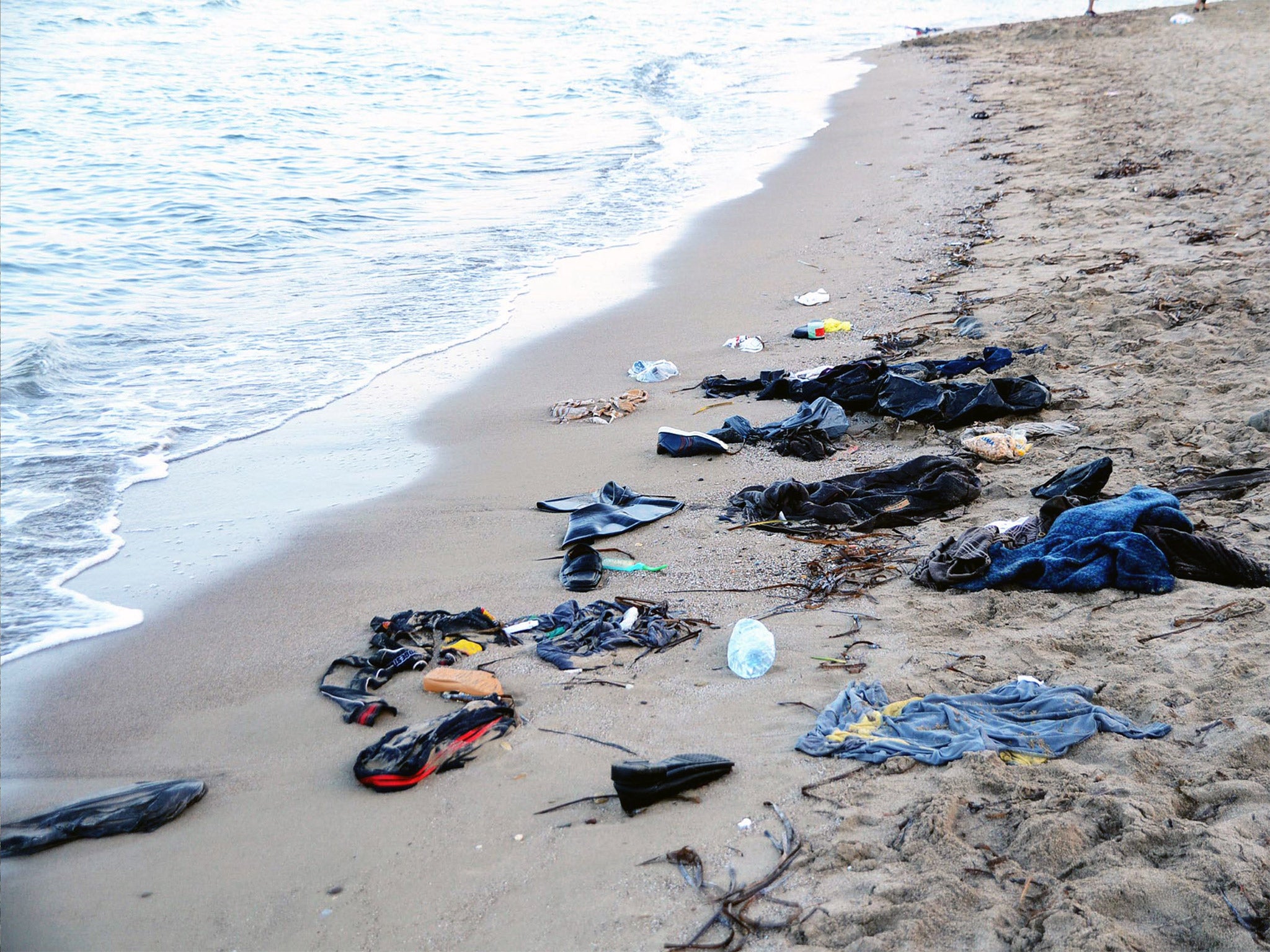 Clothes litter a beach in Bodrum, Turkey, where 11 refugees drowned on Wednesday