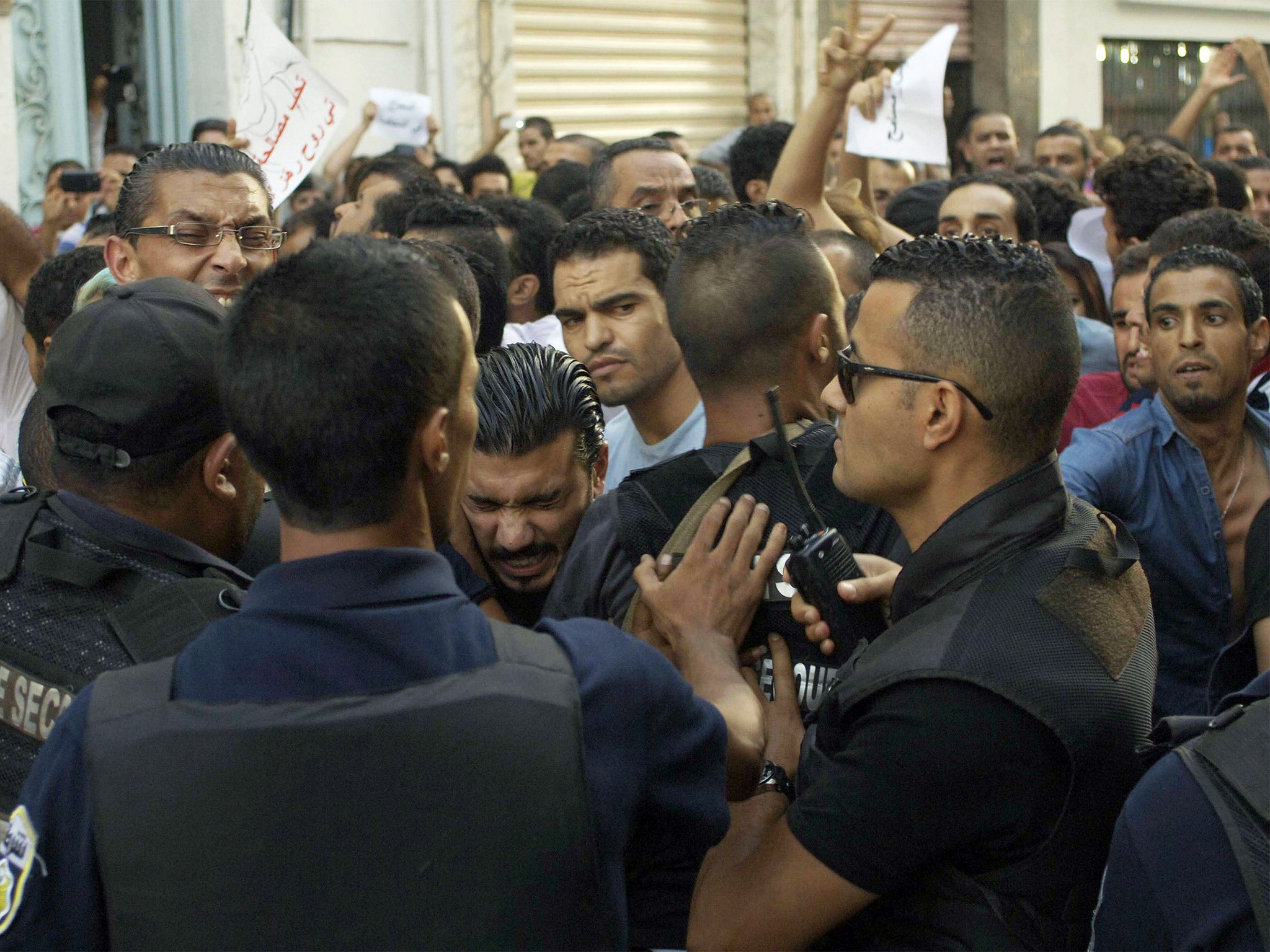 Police scuffle with demonstrators outside the headquarters of the national trade union center in Tunis, on Tuesday (Getty)