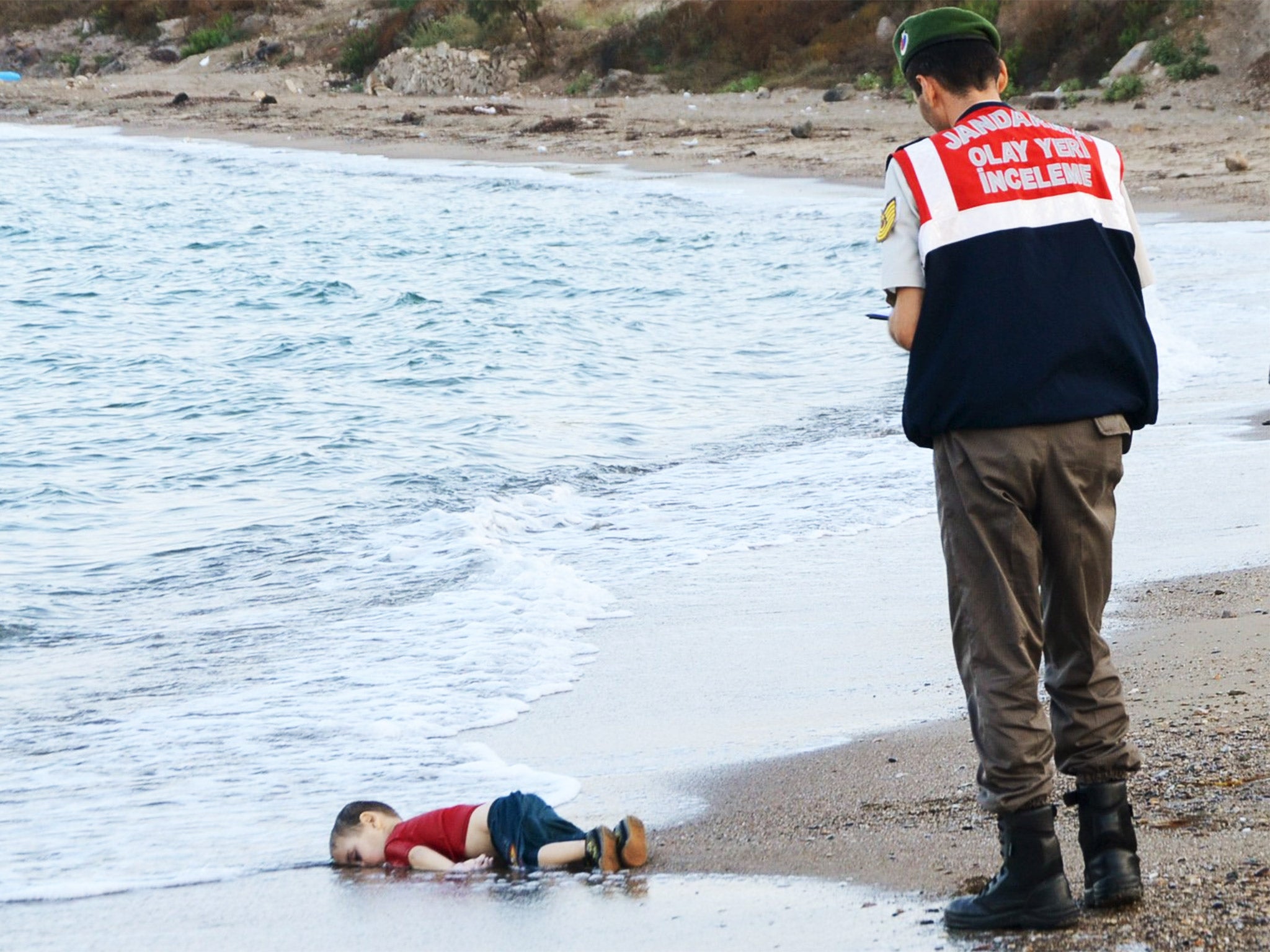 Aylan Kurdi, a young Syrian boy who drowned in his family’s attempt to reach Greece from Turkey, lies in the surf near Bodrum, Turkey