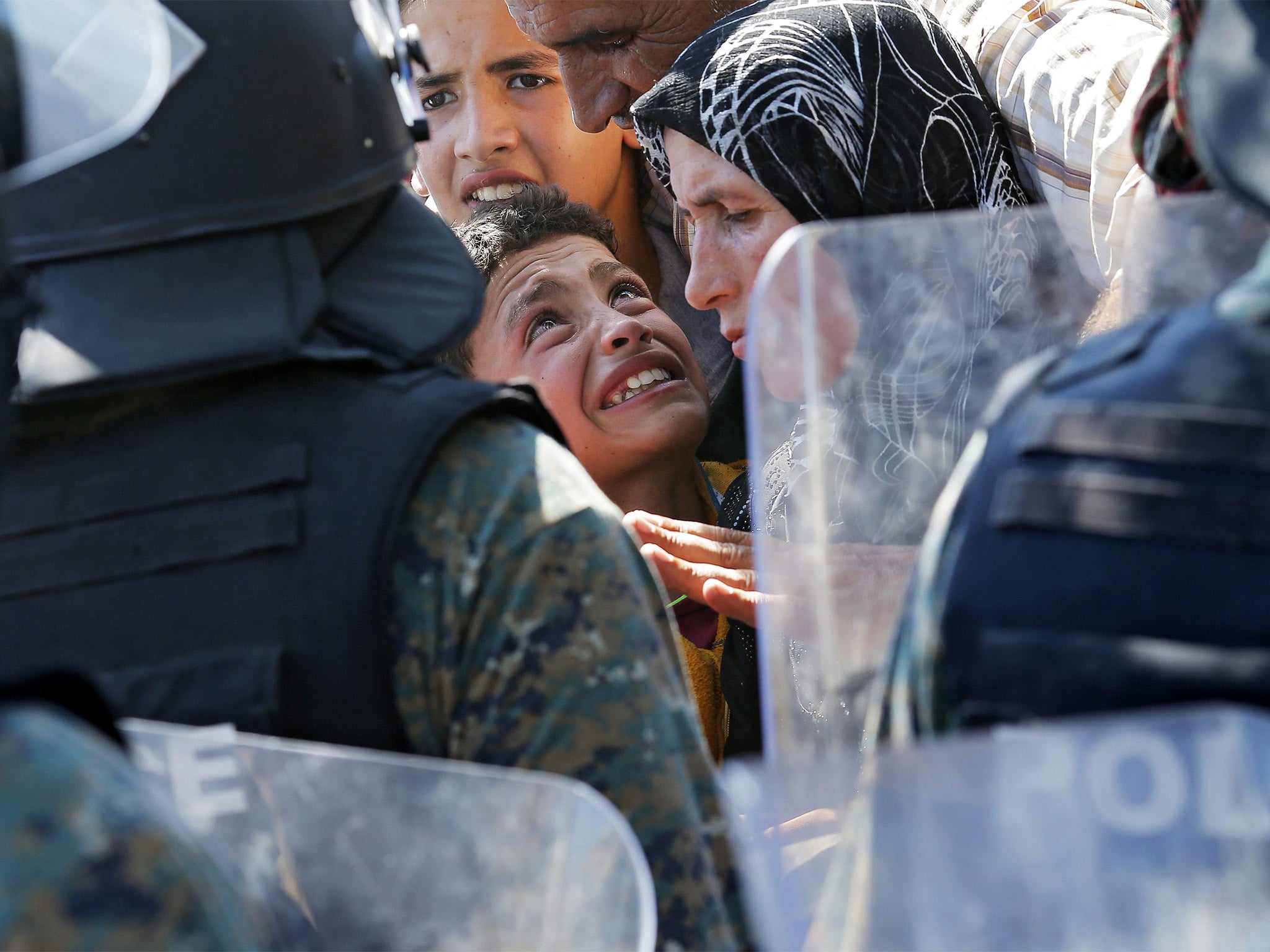 Refugees try to break through a police cordon blocking access to the border between and Greece, near the town of Gevgelija, Macedonia. The town sits on the ‘Balkan corridor’ used by refugees, mostly from Syria, to travel from Turkey to Hungary, the gateway to the EU