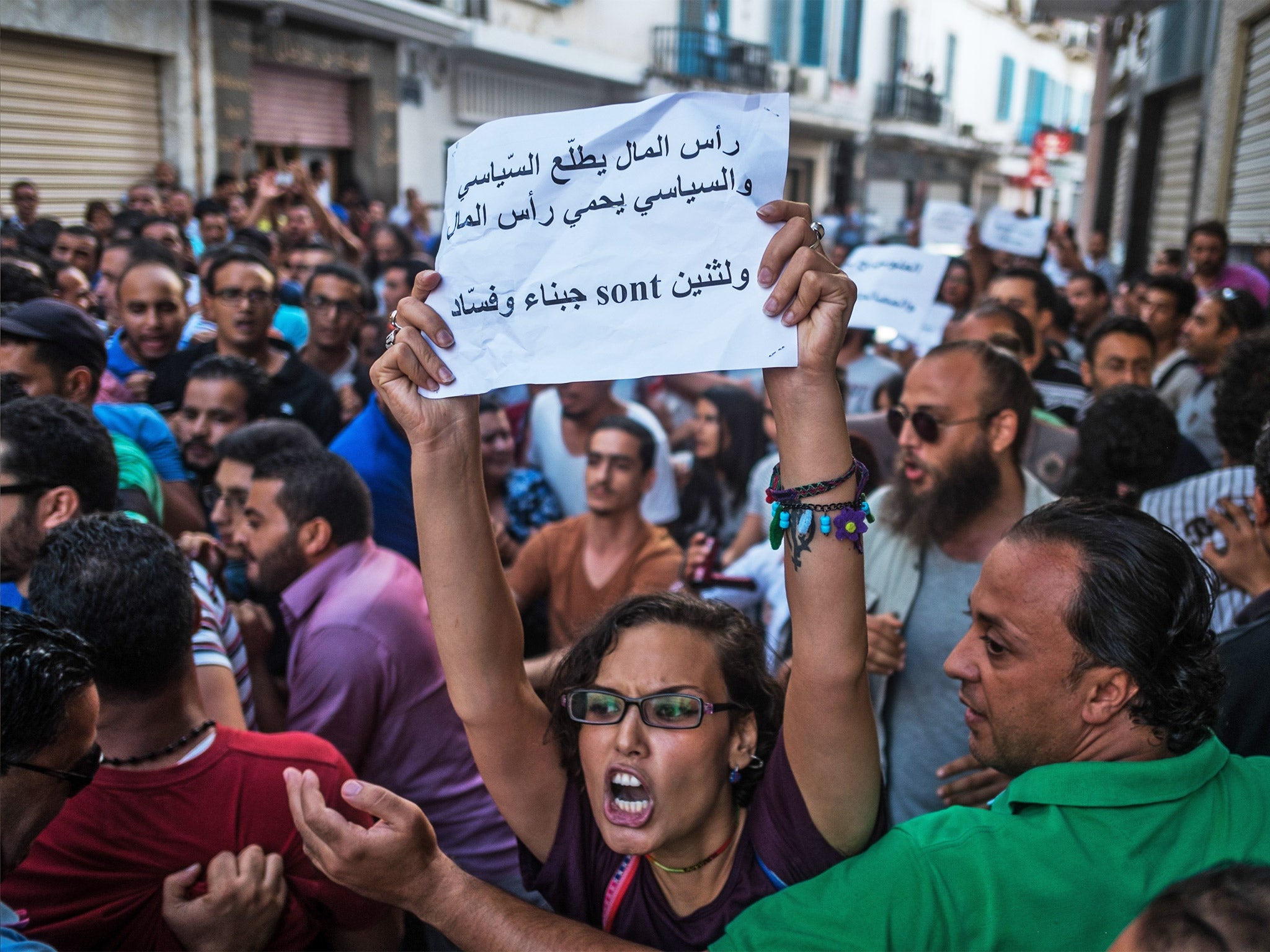 Demonstrators rally in Tunis on Tuesday against a planned financial amnesty for members of former President Zine el-Abidine Ben Ali’s regime. Some protesters were beaten up and arrested