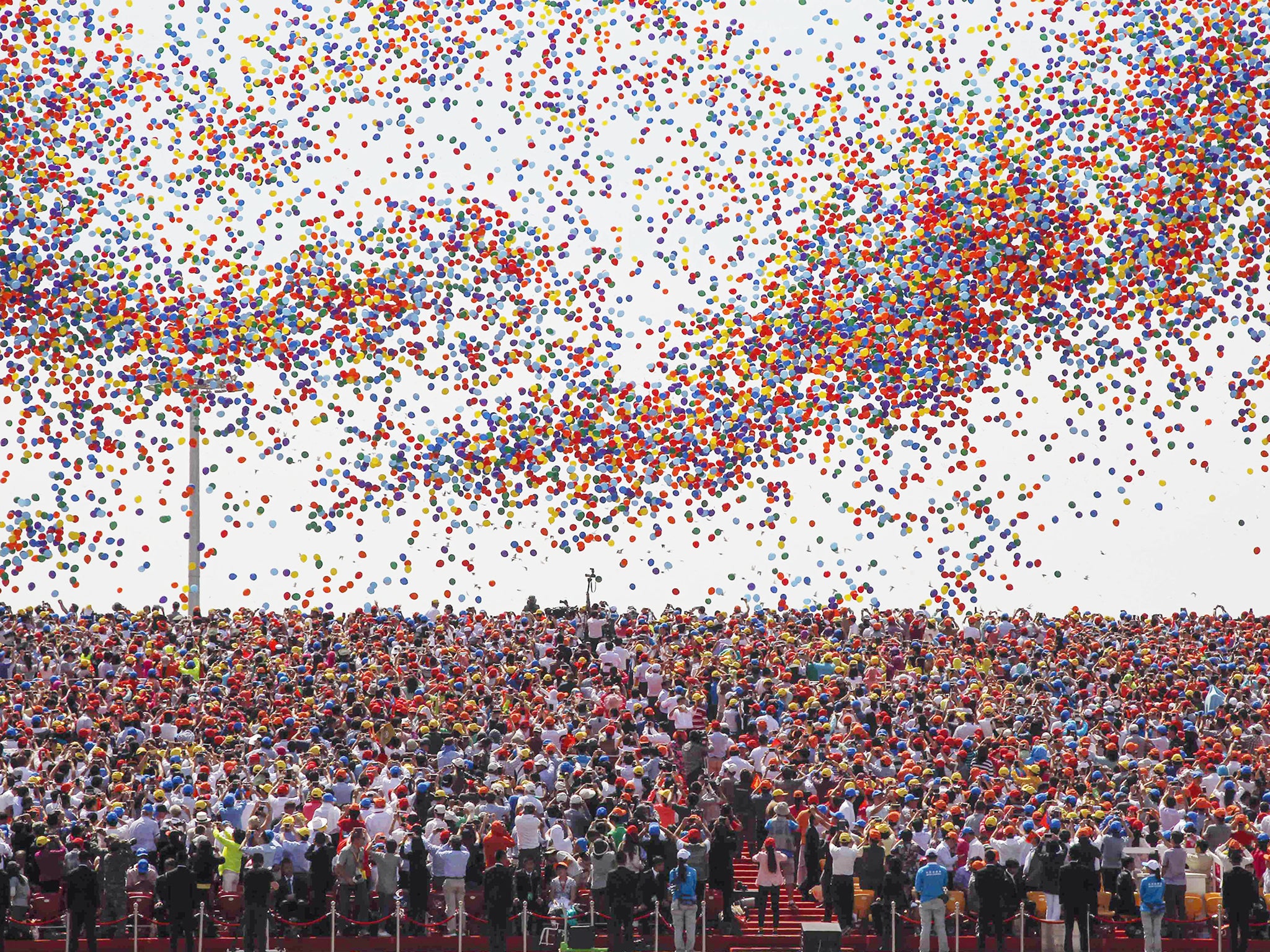 Balloons are released as a crowd looks up during a military parade over Tiananmen Square in Beijing, to mark the 70th anniversary of victory over Japan and the end of World War II