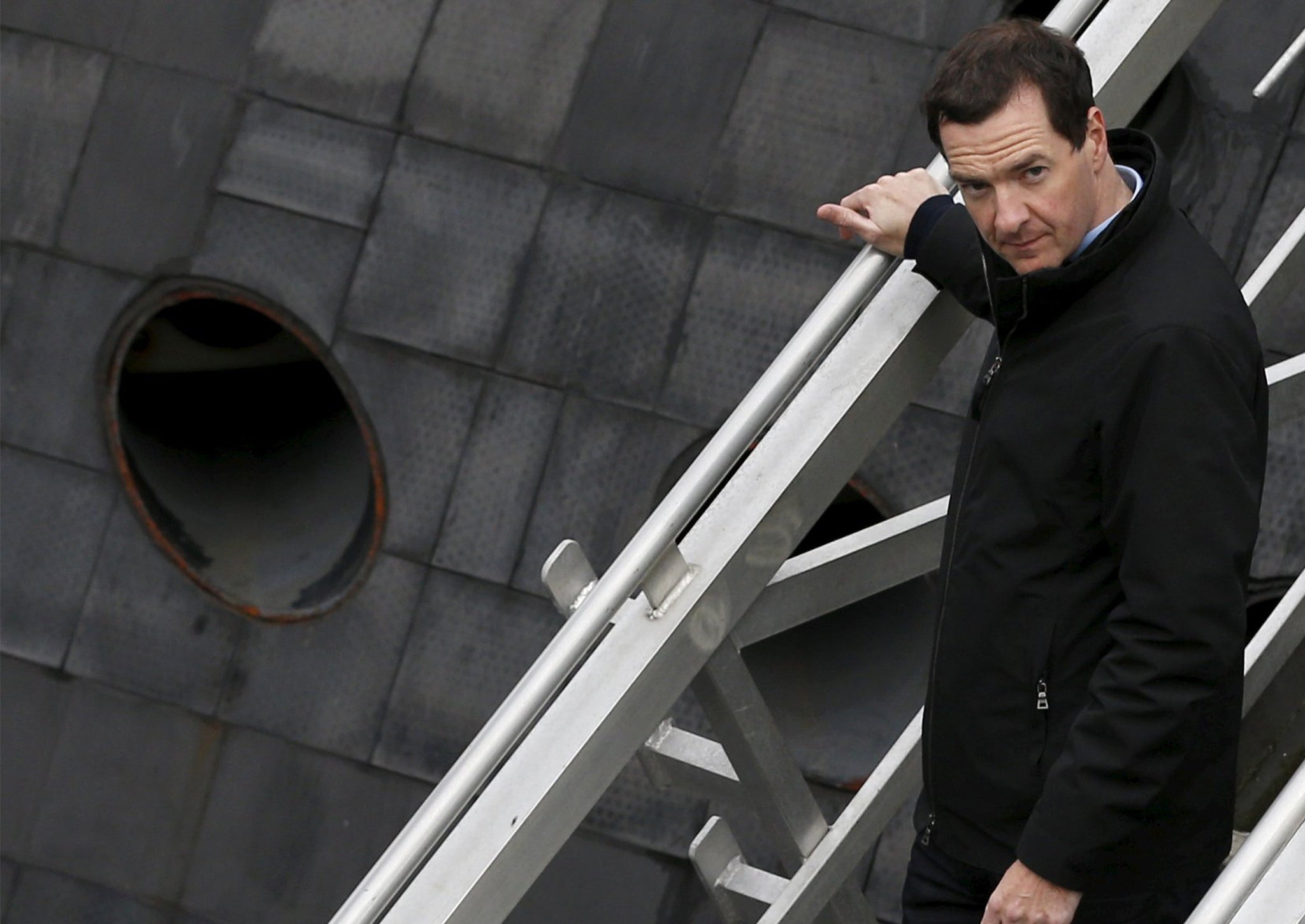 George Osborne walks down the stairs from a submarine during a visit to the Royal Navy's submarine base at Faslane on August 31, 2015 in Faslane Scotland