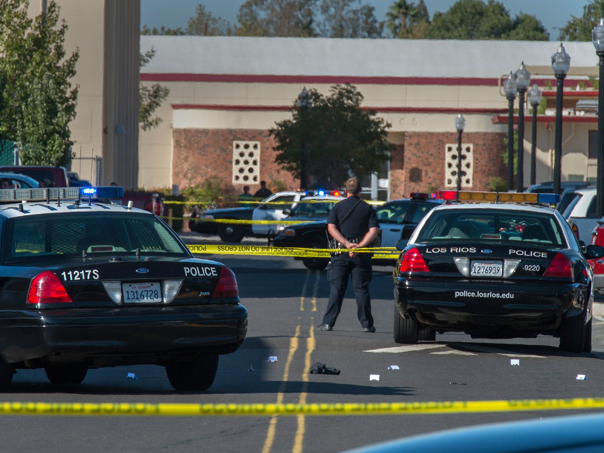 A police officer stands guard at Sacramento City College following the fatal shooting