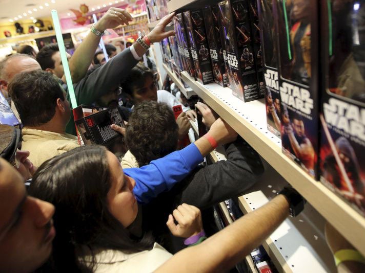 Customers pick new toys from the upcoming film "Star Wars: The Force Awakens" on "Force Friday" in Sao Paulo, Brazil, September 4, 2015