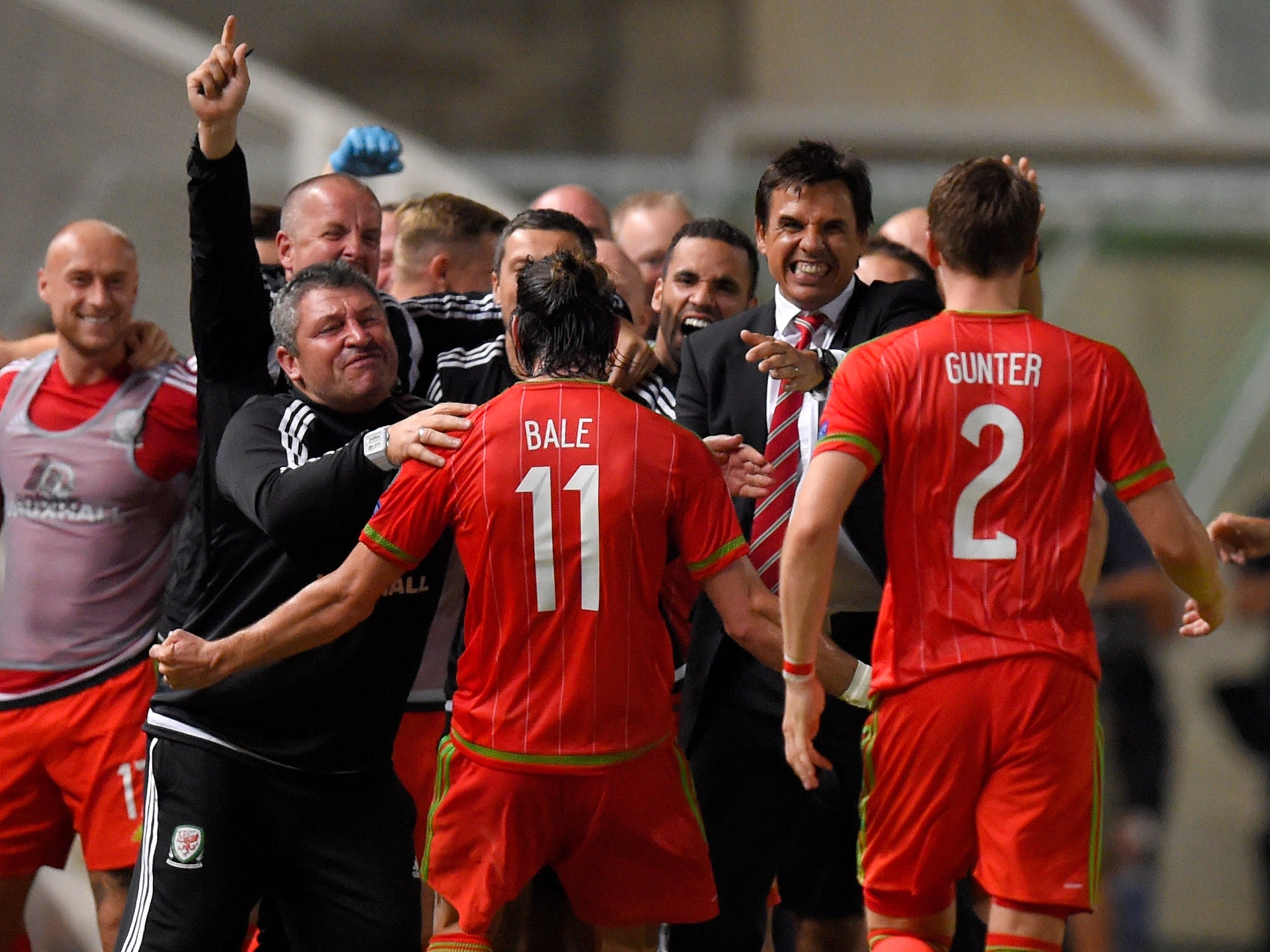 Gareth Bale celebrates with the Wales bench after scoring the winner against Cyprus