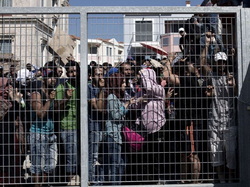 Migrants wait to be registered by the police in Lesbos on September 5, 2015.