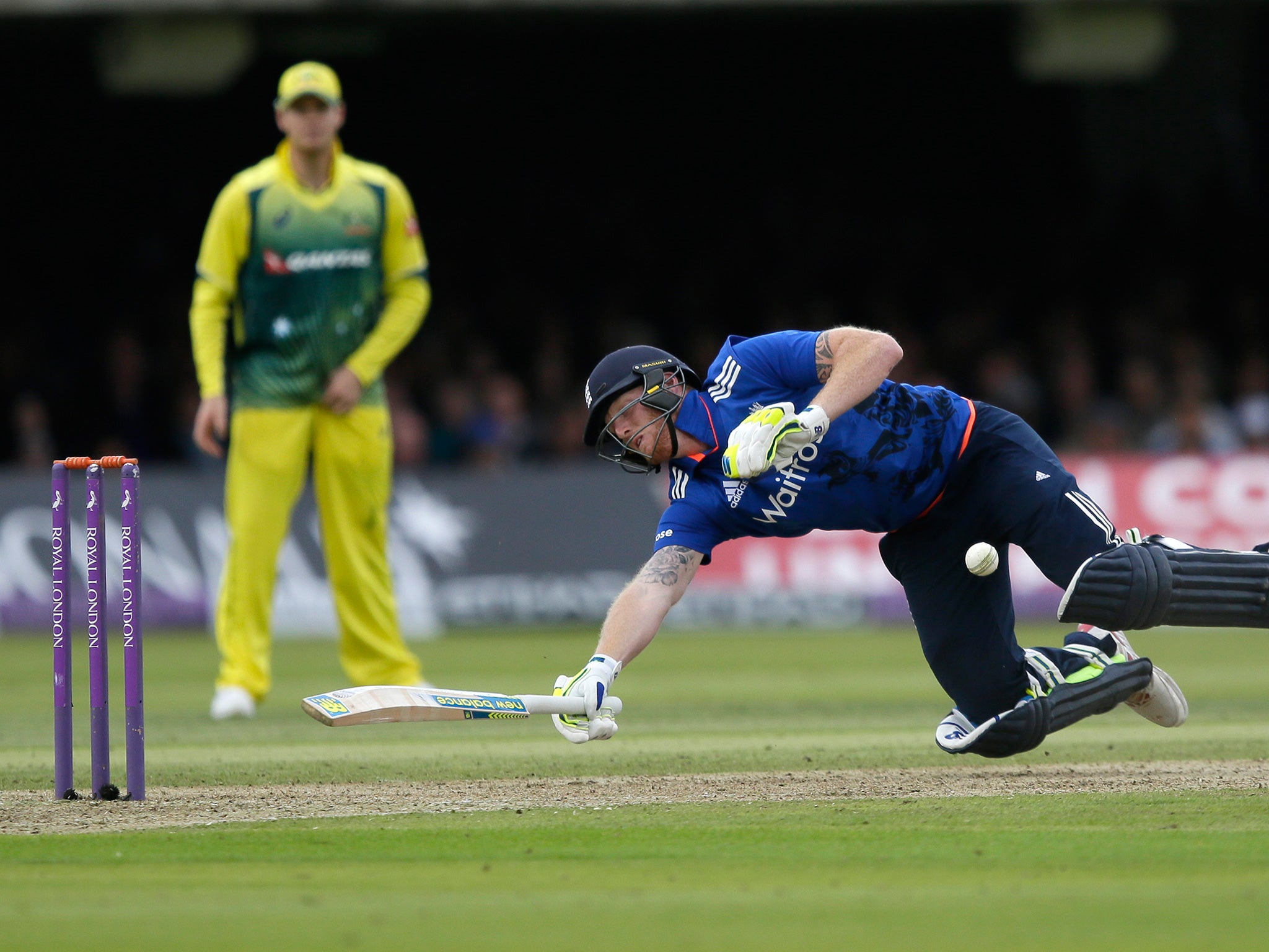 Stokes is struck by the ball as he dives for the crease