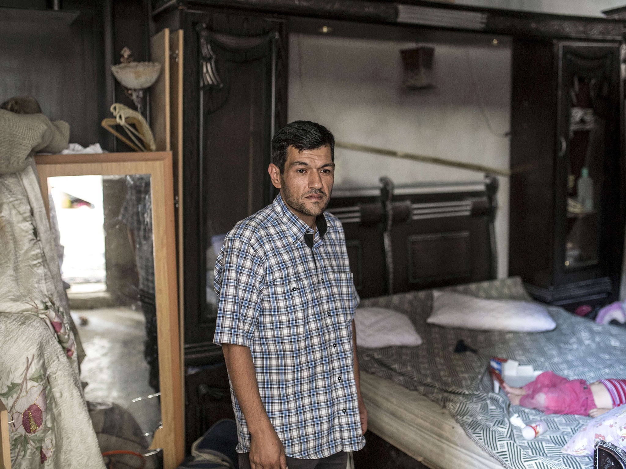 Abdullah Kurdi stands in Aylan's room in Kobane