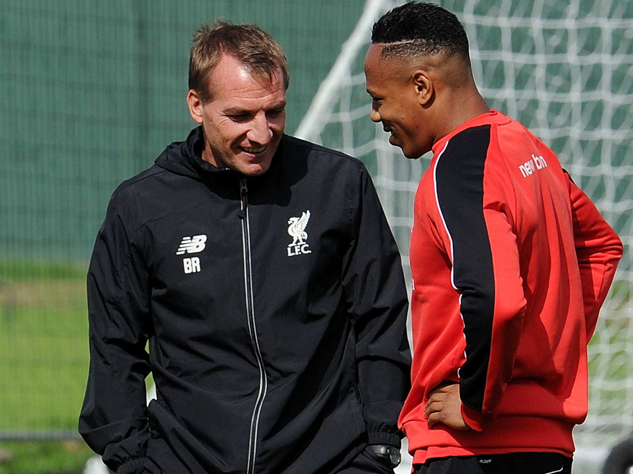 Brendan Rodgers speaks with Nathaniel Clyne (right) during training