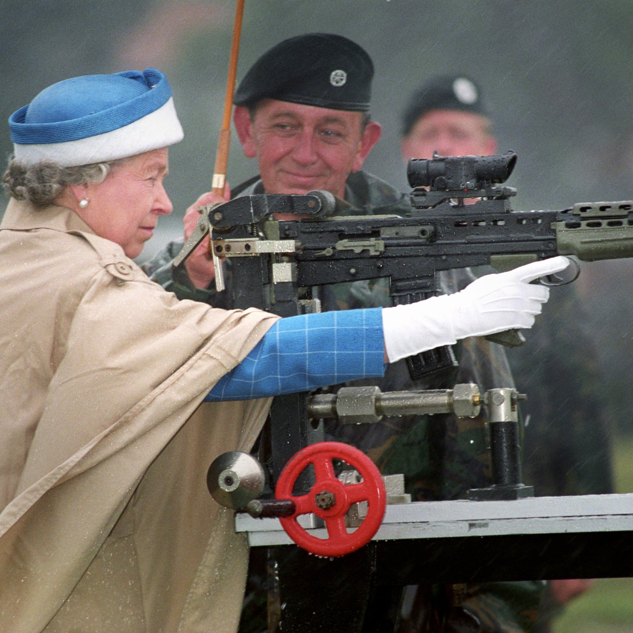 Queen Elizabeth II, with Chief Instructor, Small Arms Corp LT Col George Harvey, firing the last shot on a standard SA 80 rifle when she attended the centenary of the Army Rifle Association at Bisley, 1993