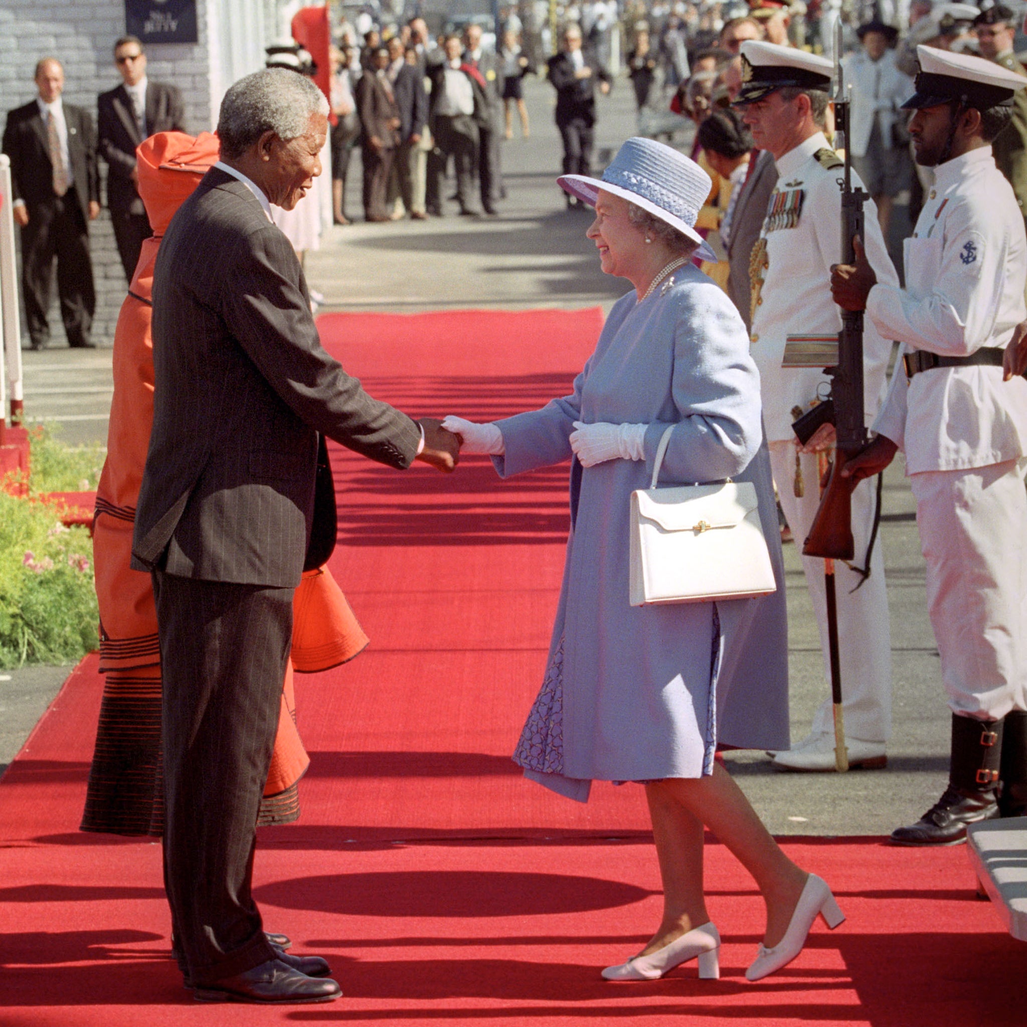 South Africa's President, Nelson Mandela, greets Queen Elizabeth II as she steps from the royal yacht Britannia in Cape Town in 1995. It’s her first visit to the country since 1947