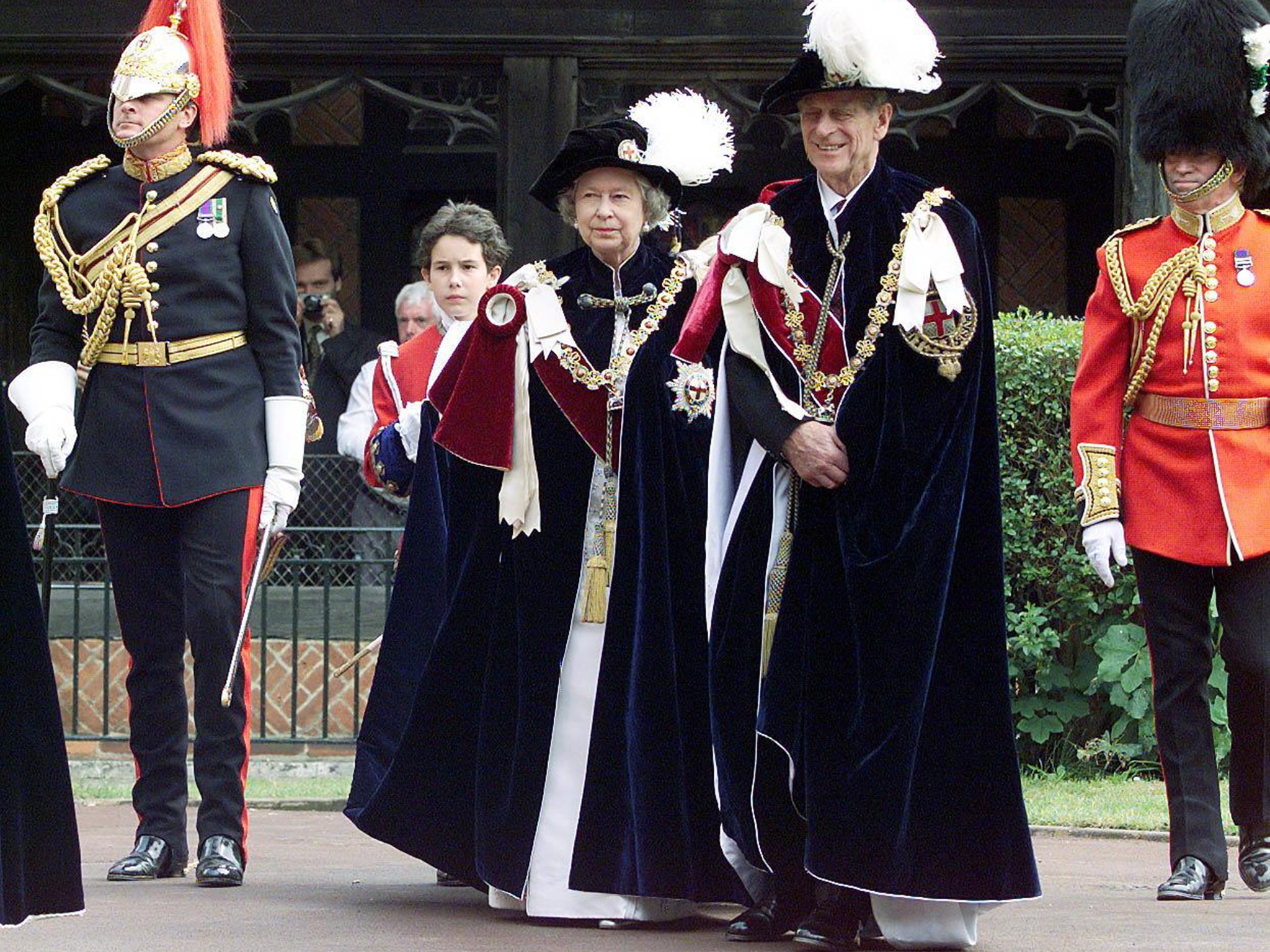 Queen Elizabeth II, accompanied by the Duke of Edinburgh, make their way into St. George's Chapel at Windsor for the annual Garter ceremony, 1999