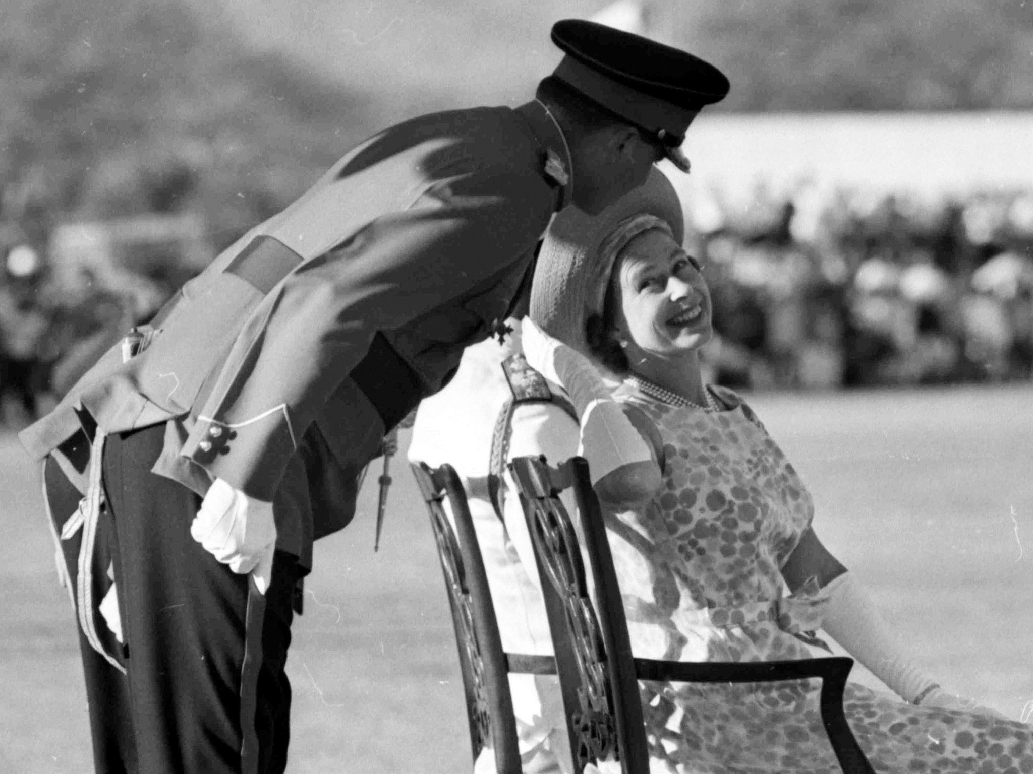 Queen Elizabeth II as she turns to smile and talk to an unidentified officer, during the Trooping of the Colour by the First Battalion of the Jamaica Regiment at Up-Park Camp, Kingston, Jamaica, 1966