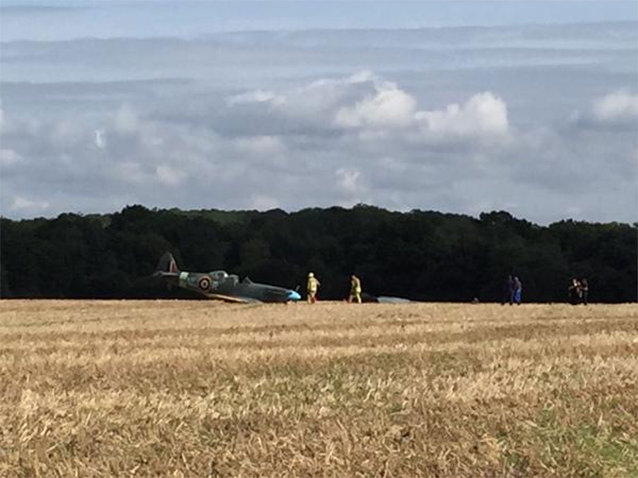 Photograph after a Spitfire crash in Ashford, Kent, taken by an eyewitness, shows emergency services arriving on the scene