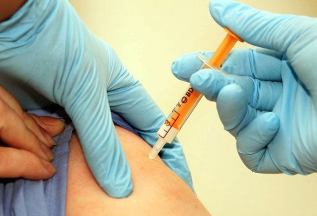 A patient is given a swine flu vaccination in London