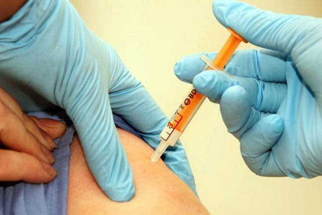 A patient is given a swine flu vaccination in London