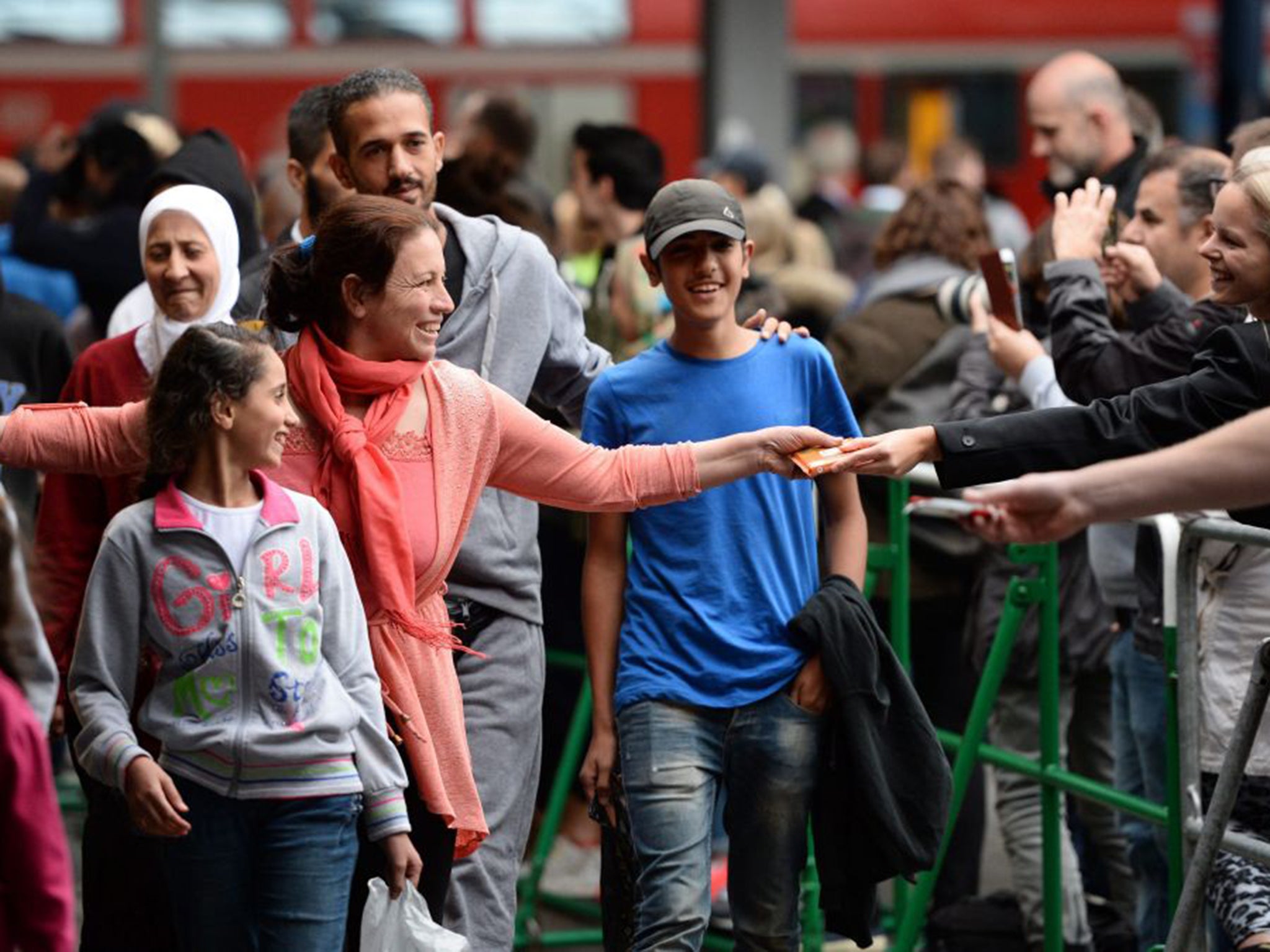 Refugees arrive at the central railway station in Munich, welcomed with open arms