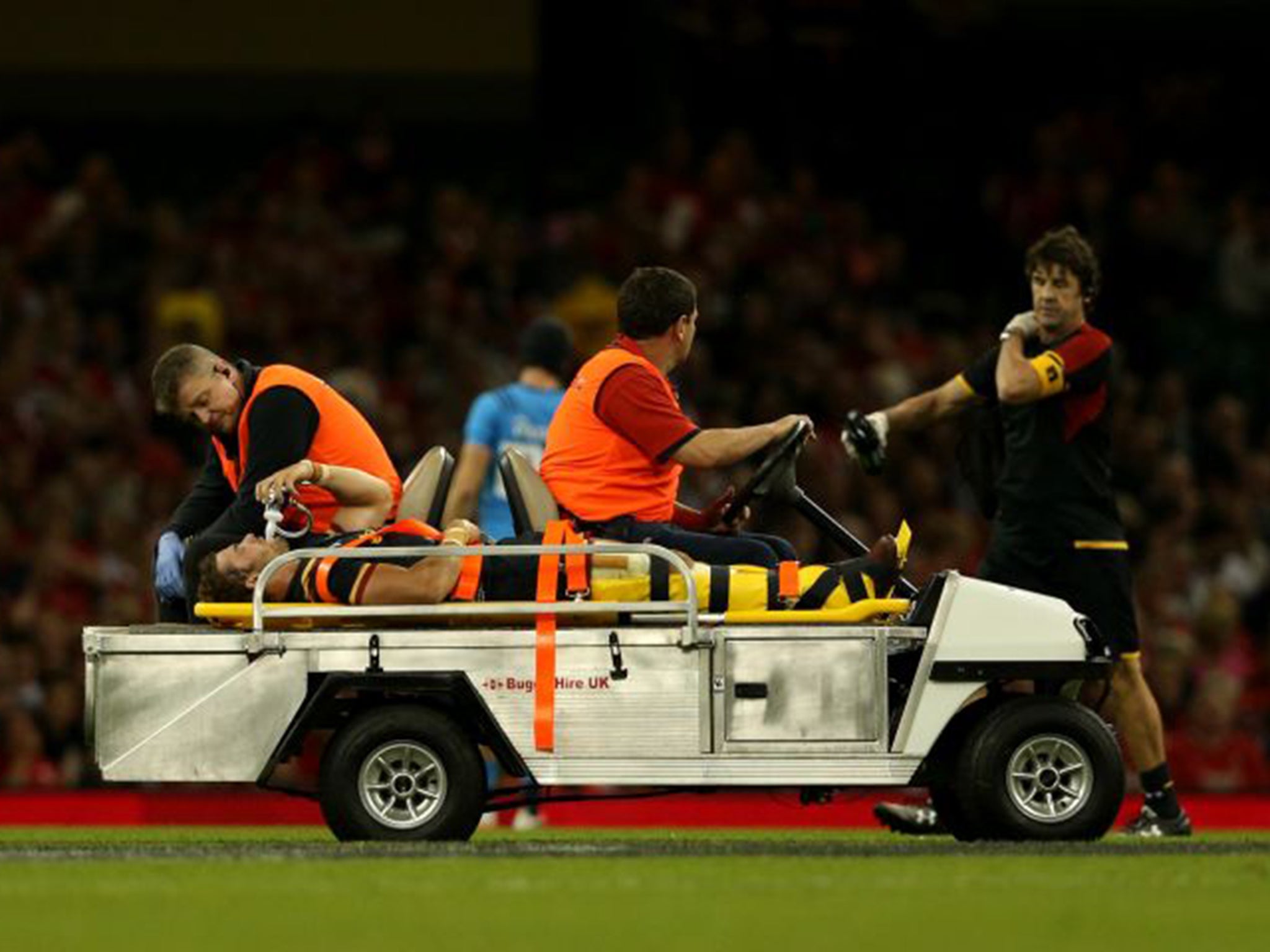 Leigh Halfpenny is taken off the pitch on a stretcher after injuring his knee against Italy