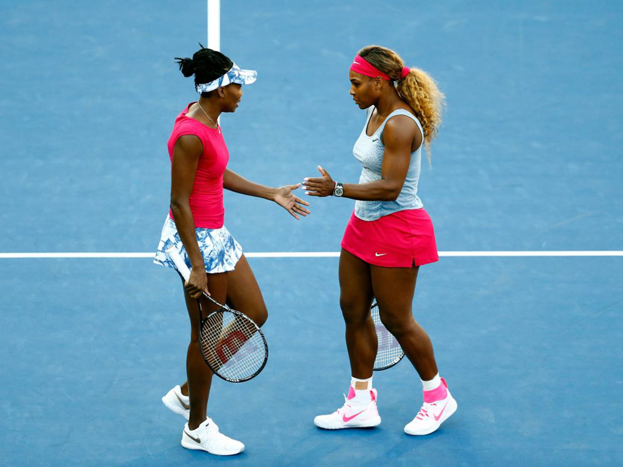 Venus Williams, left, and sister Serena playing doubles at the US Open last year