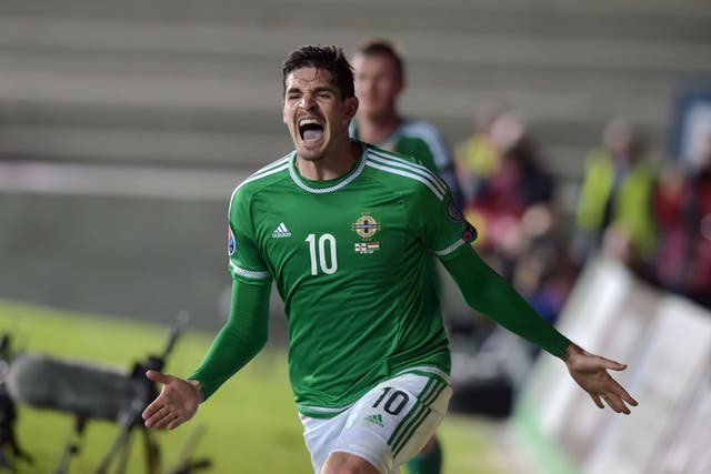Kyle Lafferty celebrates scoring 10-man Northern Ireland’s equaliser deep in injury time as they salvaged a vital 1-1 draw against Hungary at Windsor Park 