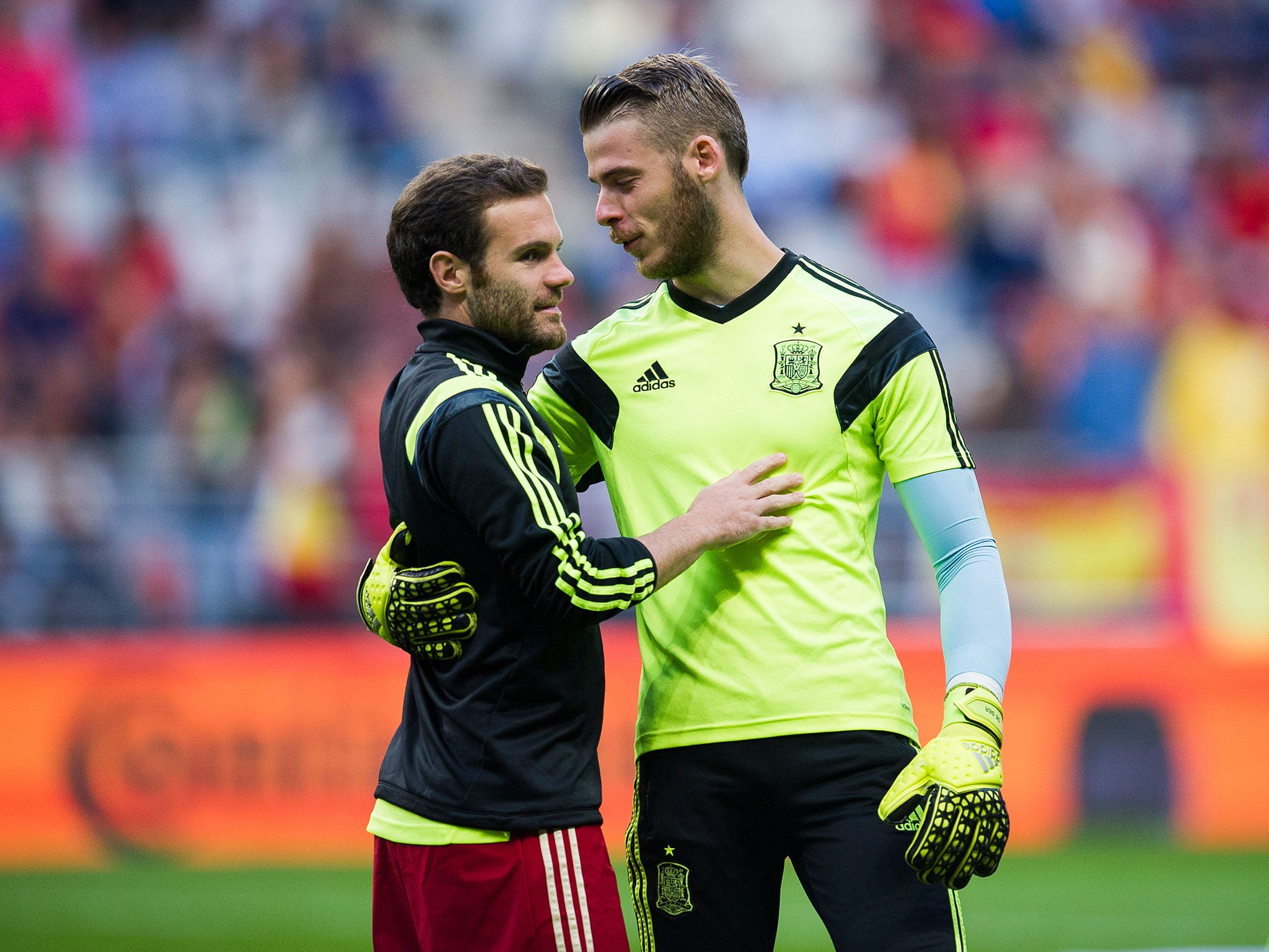 Juan Mata hugs David De Gea during Spain training