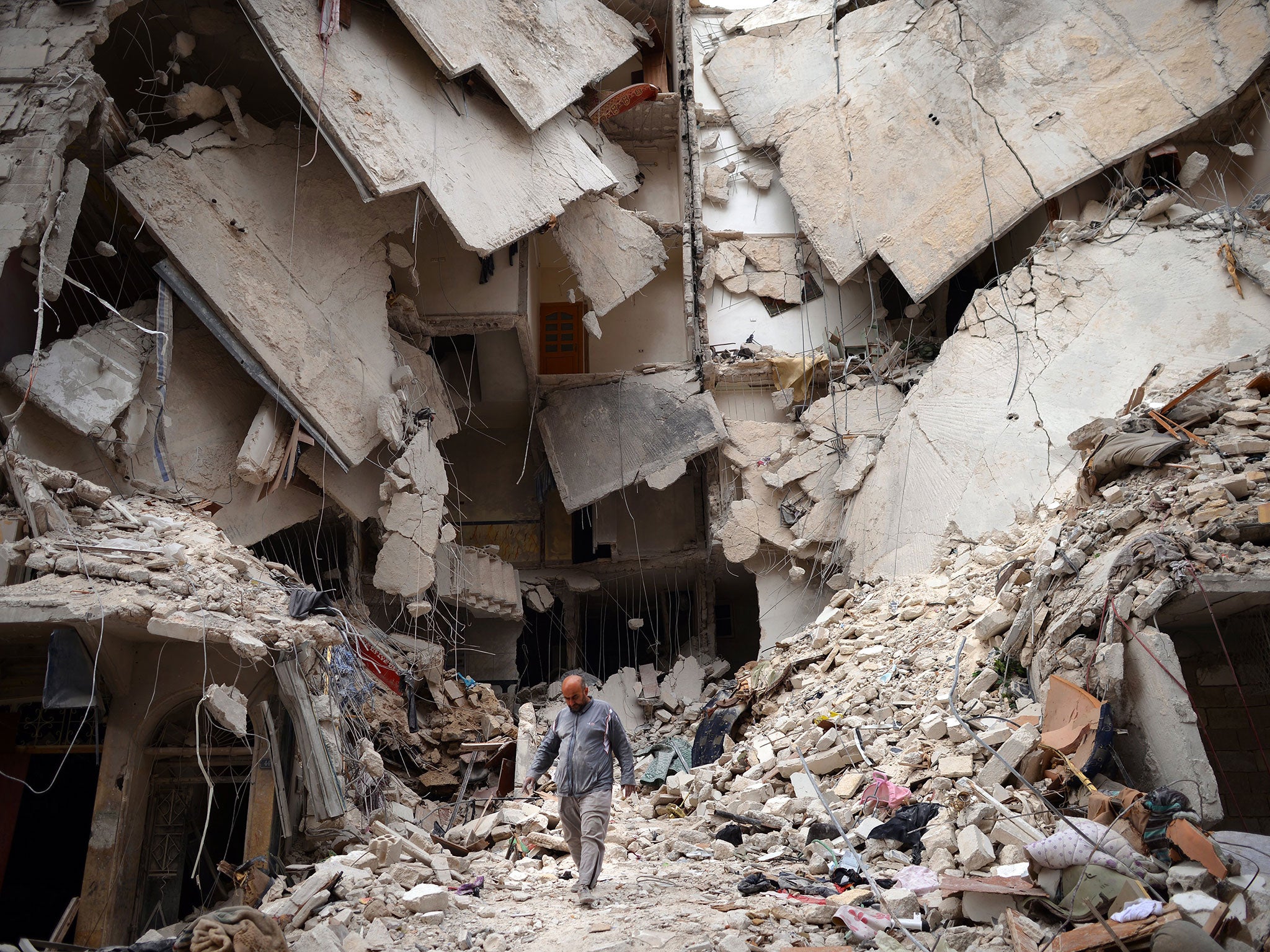 A Syrian man walks amid destruction in the northern Syrian city of Aleppo on April 10, 2013.