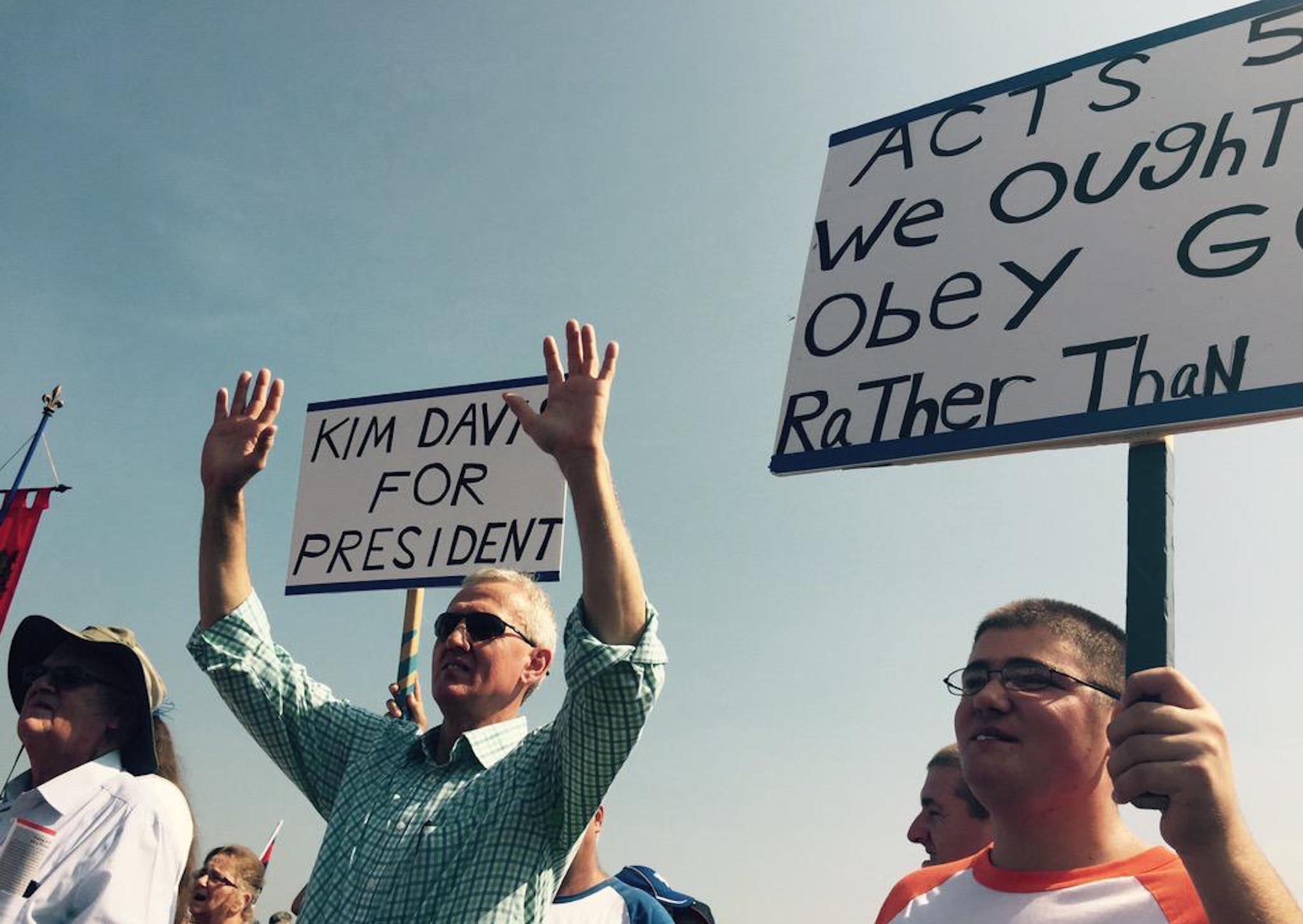 Supporters of Kim Davis hold up signs outside the Carter County Detention Center.