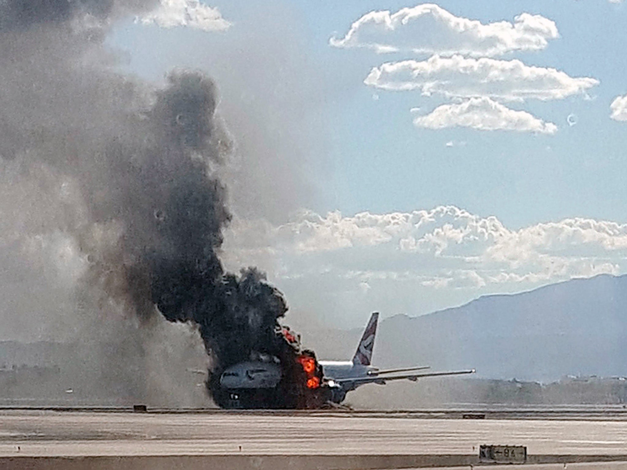 Smoke billows out from a plane that caught fire at McCarren International Airport, Nevada