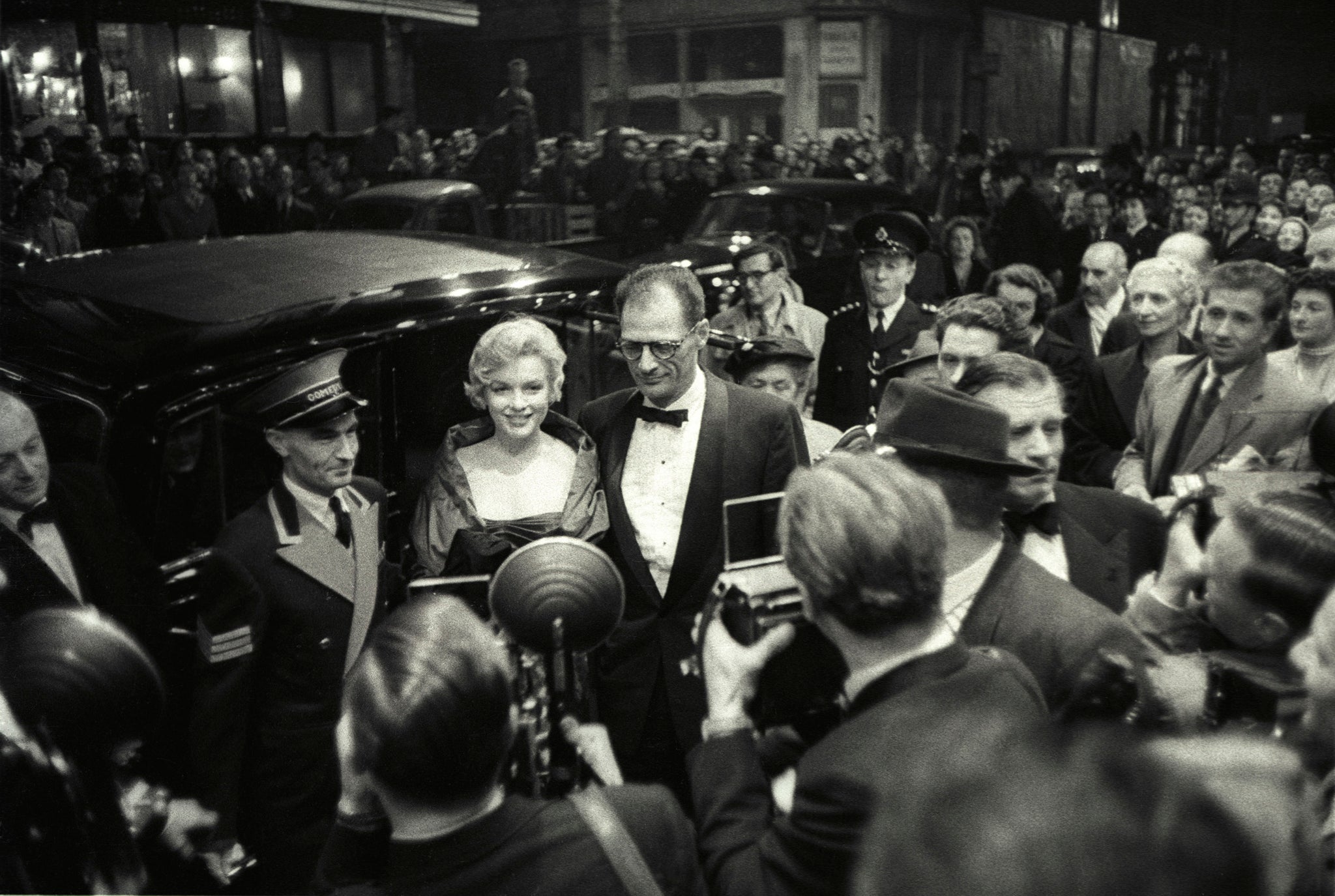 Marilyn Monroe - portrait with husband, Arthur Miller - American actress at play opening - greeted by crowd and photographers - Laurence Olivier at centre-right - Comedy Theatre, London - October 1956. --- Image by © B.Seed/Lebrecht Music & Arts/Lebrecht