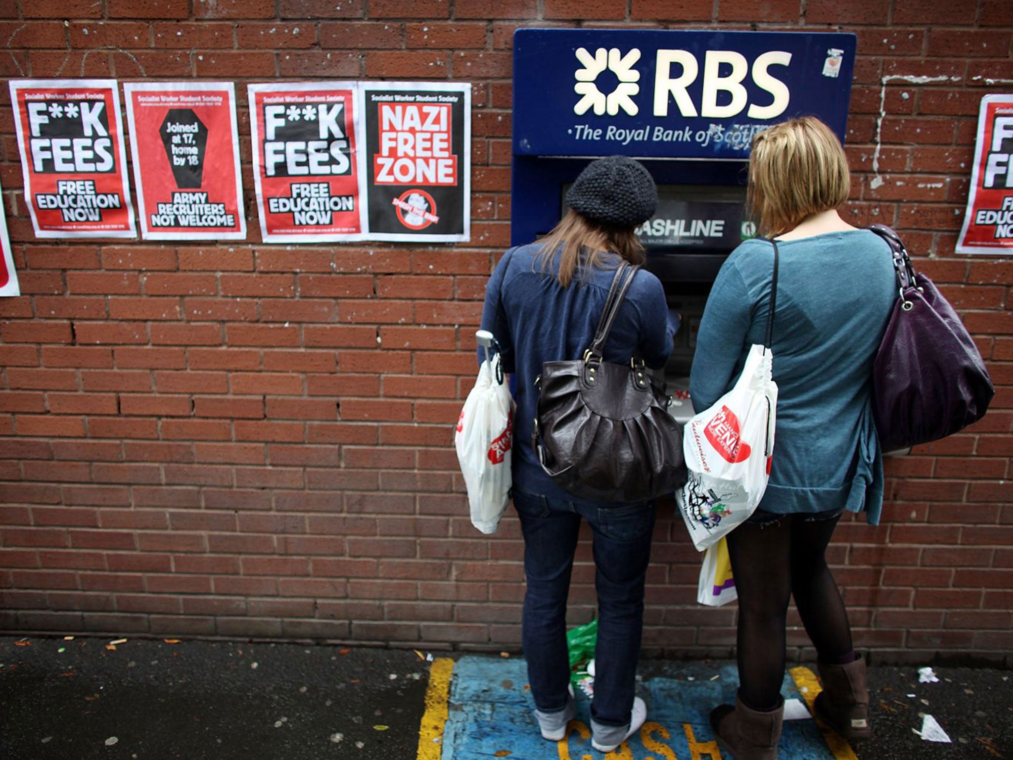 Students arriving for Manchester University's freshers week queue up at a cash machine