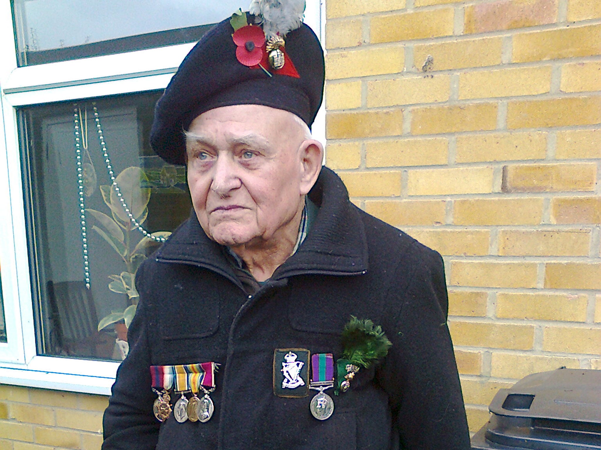 John Spicer, 92, pictured on Remembrance Day last year. He and his son Frank are among thousands of ordinary Britons offering up their spare room to Syrian refugees