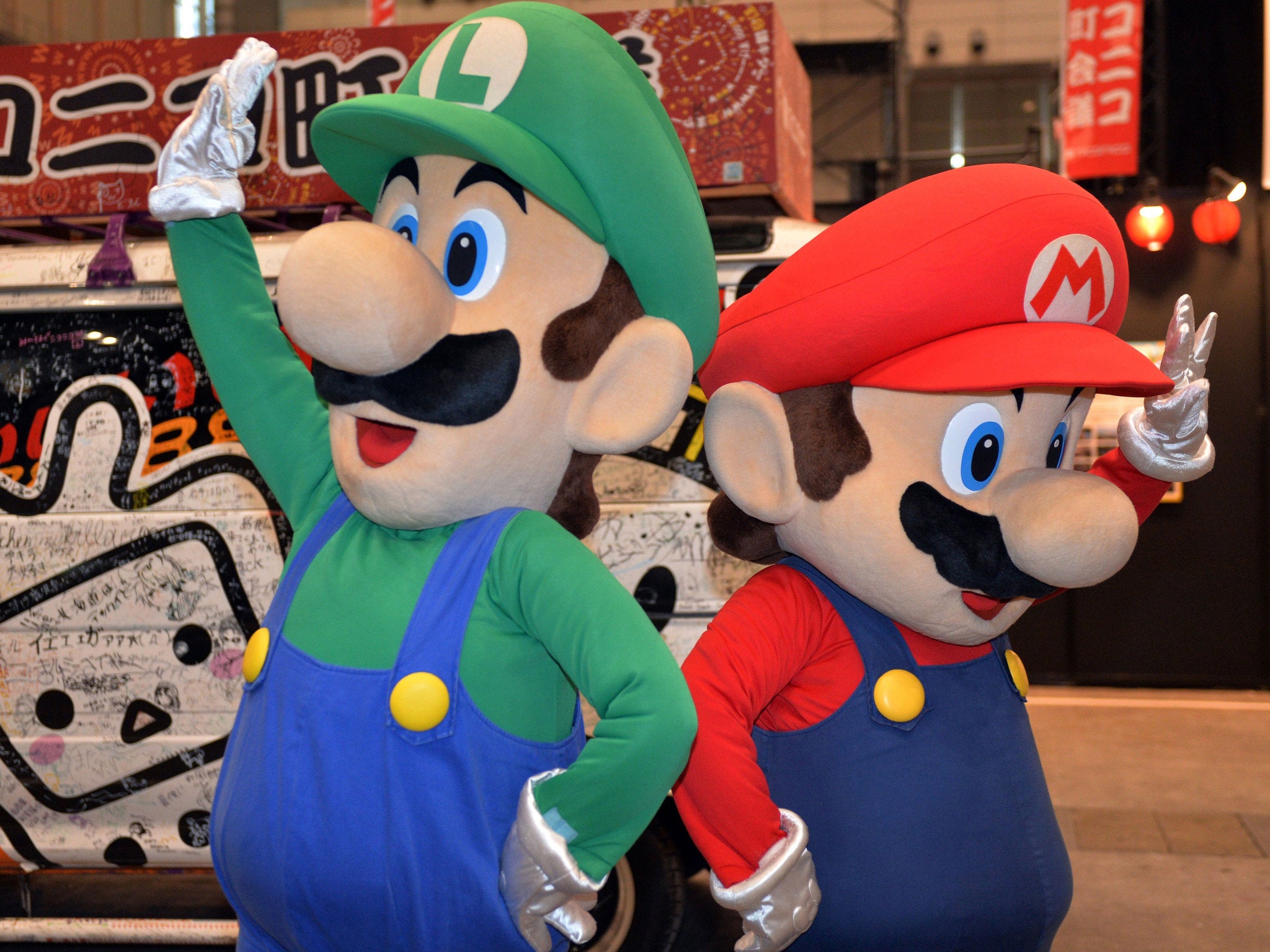 This picture taken on April 26, 2014 shows Japanese videogame giant Nintendo's characters Super Mario and Luigi (L) performing in Chiba, suburban Tokyo