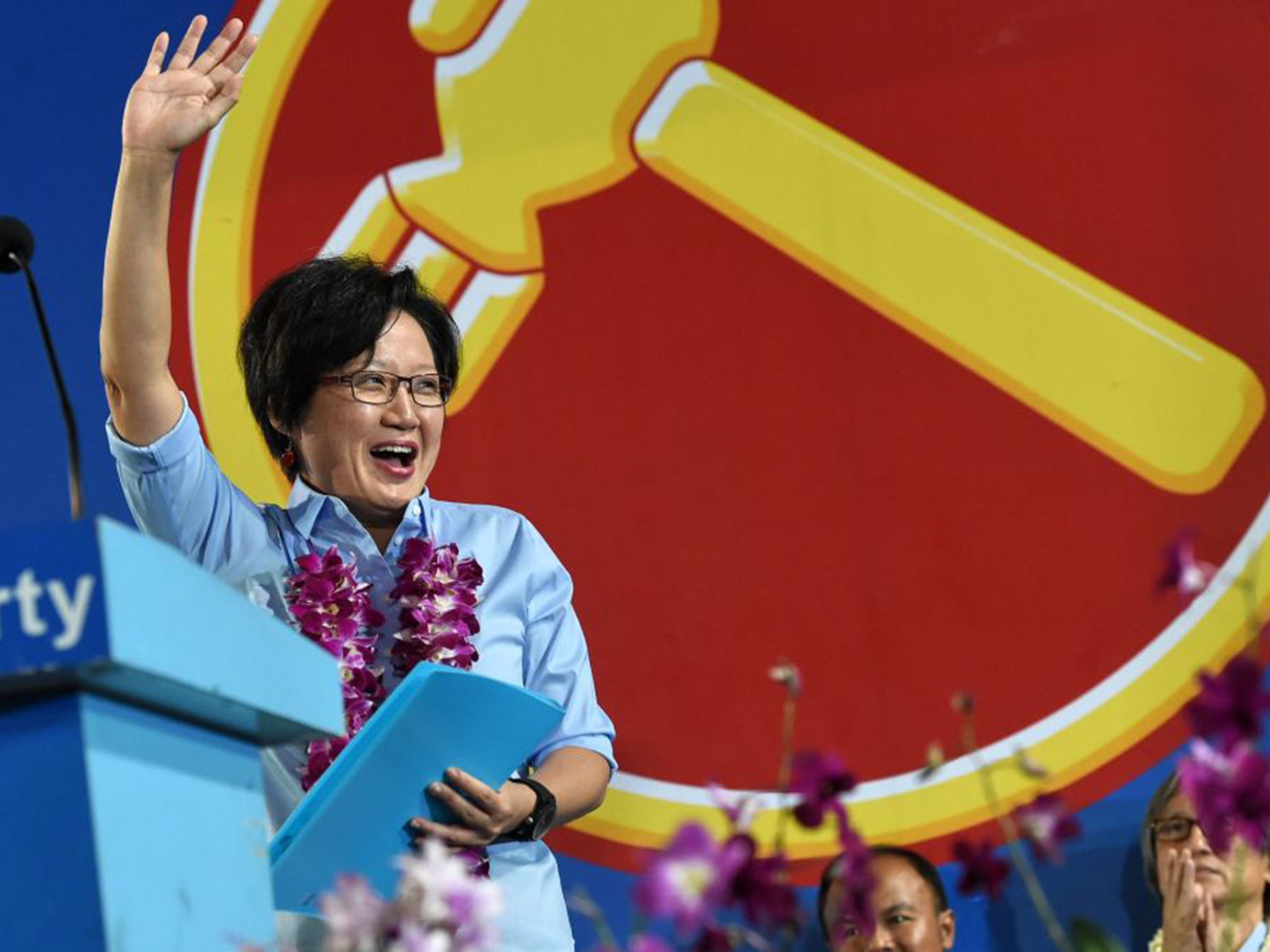 Sylvia Lim waves to supporters at a rally ahead Friday’s election